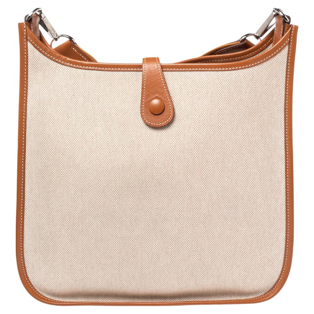 Hermes is a brand that delivers crafts with art and creativity. Crafted from canvas and leather and featuring an adjustable shoulder strap, this Evelyne I PM is a classic. The bag comes with a spacious unlined interior. It carries a large perforated