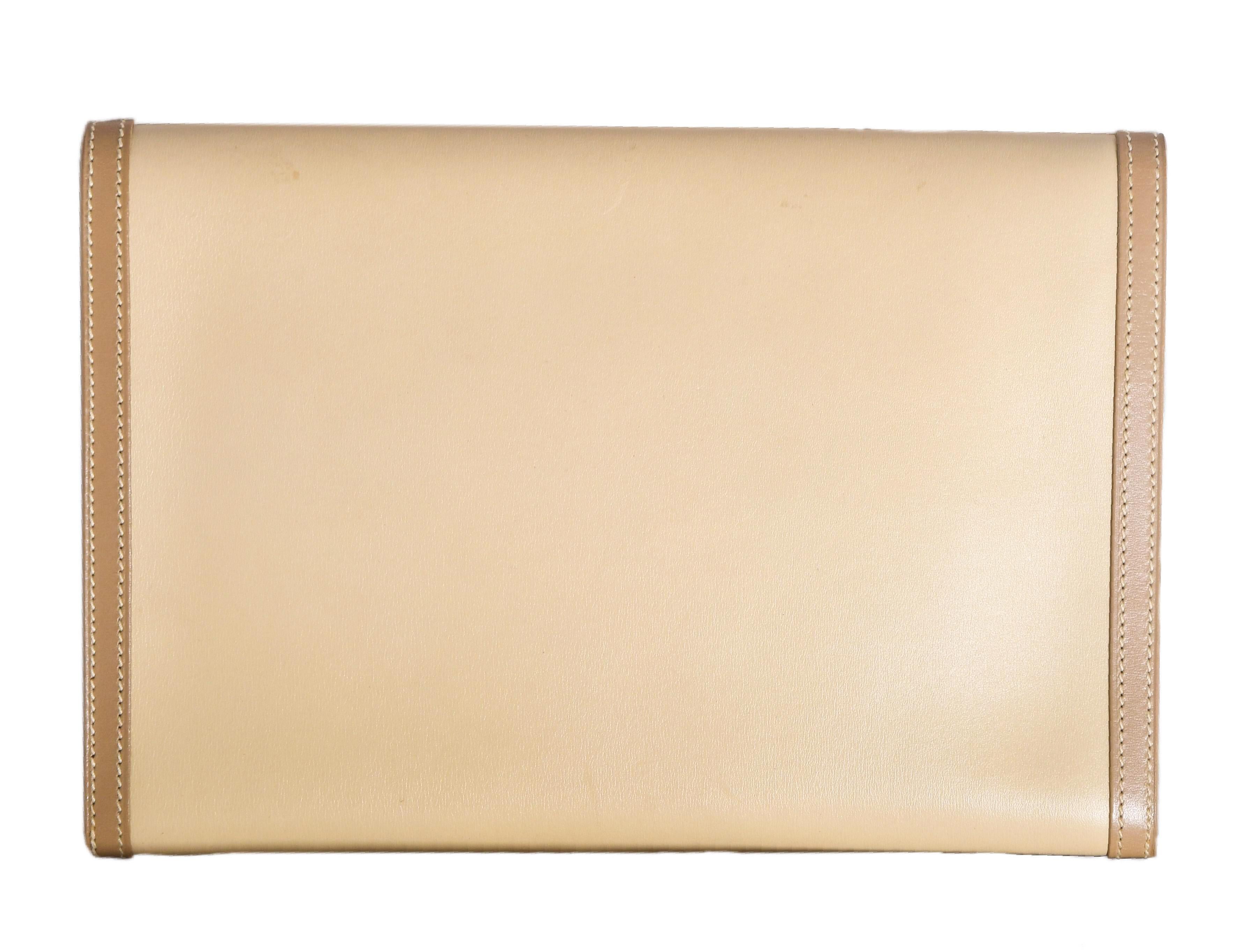Hermes beige leather envelope flap bag is trimmed in tan leather around the sides and on the flap.  This evening clutch is lined in same beige color leather as on the exterior.  With a single interior pocket, it does contain any other pockets.  For