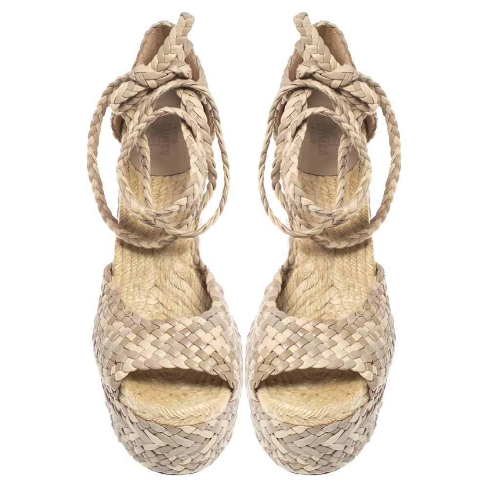 Get these Epice Tresse sandals home today, crafted by the house of Hermes. Having a woven exterior made from leather suede and canvas, the sandals are contemporary and chic. They have wedge heels, ankle wraps, and espadrille insoles.

Includes: