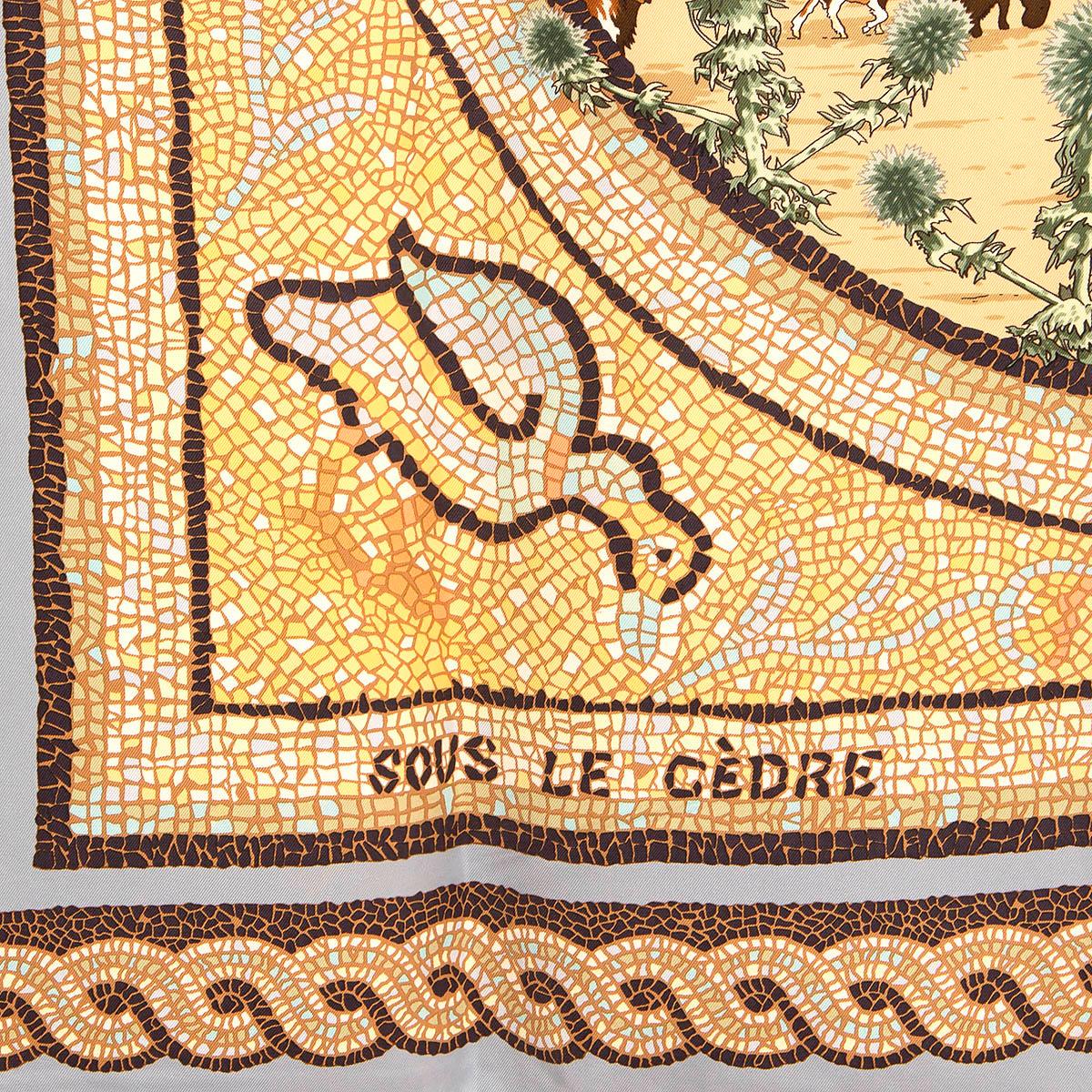 100% authentic Hermès 'Sous le Cedre 90' scarf by Dimitri Rybaltchenko in beige silk twill (100%) with light blue border and details in green and yellow. Has been worn and is in excellent condition.

Issued in 1998

Story Behind:

Cavalcadour is a