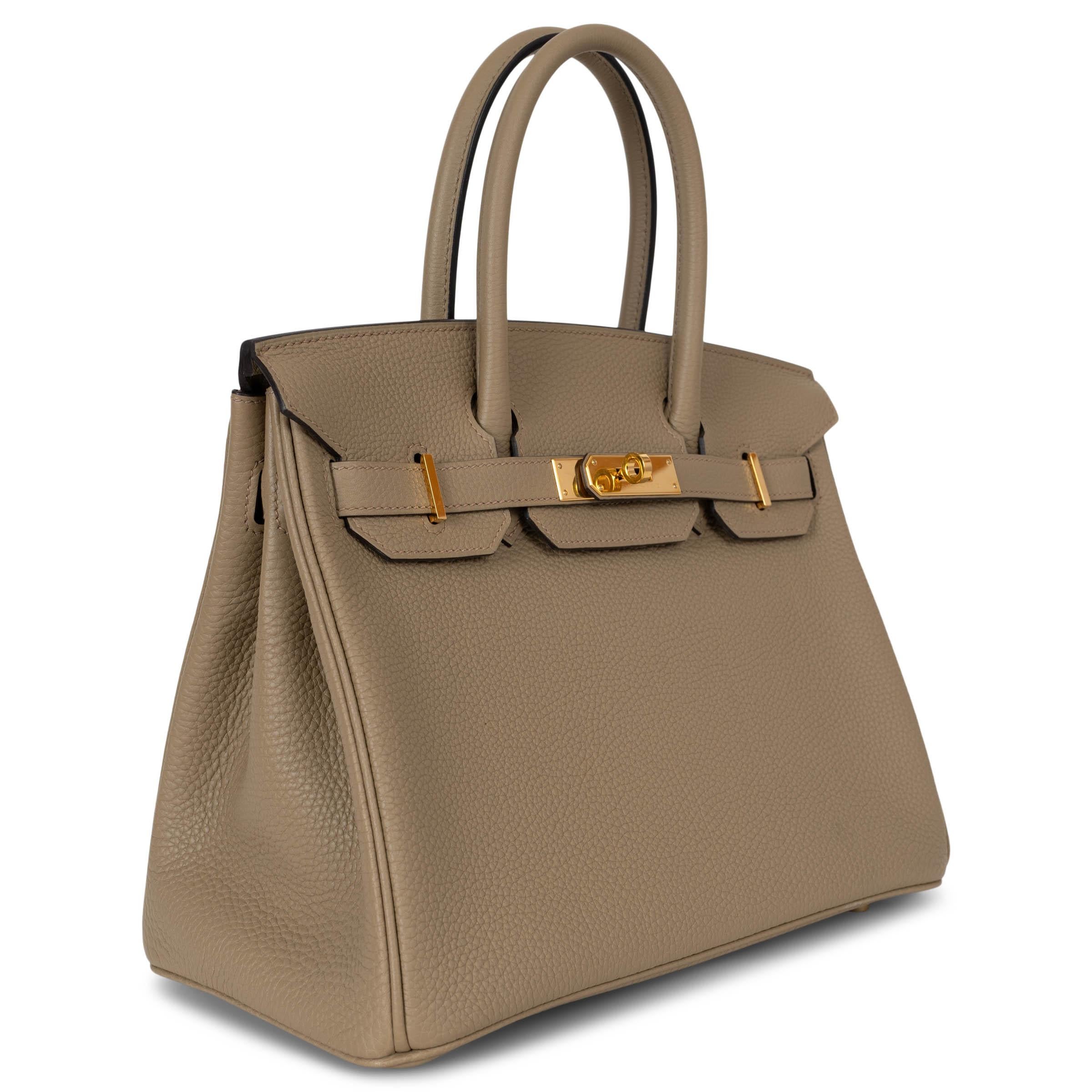 This 100% authentic Hermès Birkin 30 bag is crafted from luxurious Beige Marfa Veau Togo leather, showcasing elegant gold-plated hardware. The interior is lined in Chèvre (goat skin) and features an open pocket against the front and a zipper pocket