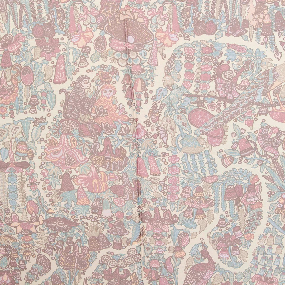 100% authentic Hermès 140 Legende Moghole Mousseline silk (100%) chiffon scarf circa 2008 features an elaborate design of florals and animals on a background of sand with details in turquoise, lilac, pale yellow, light grey and purple. Has been worn