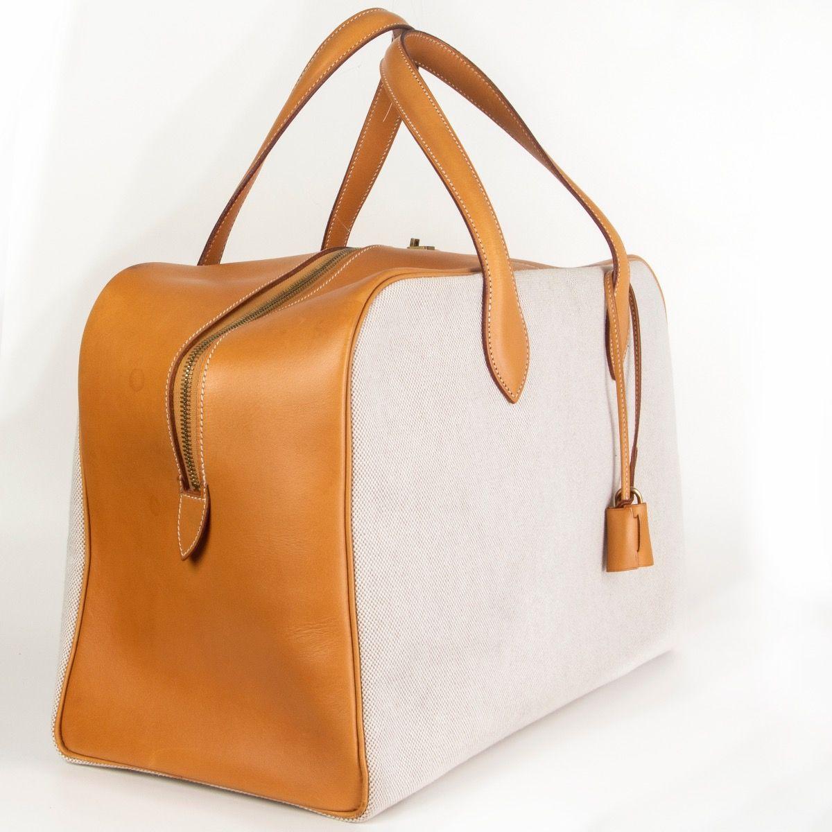 100% authentic Hermes 'Victoria 45' bag in Natural (tan beige) Vache Natural leather and oatmeal Toile H canvas. Closes with a zipper on top. Lined in cotton. Has been carried with some marks on the leather - see photos. Overall in very good