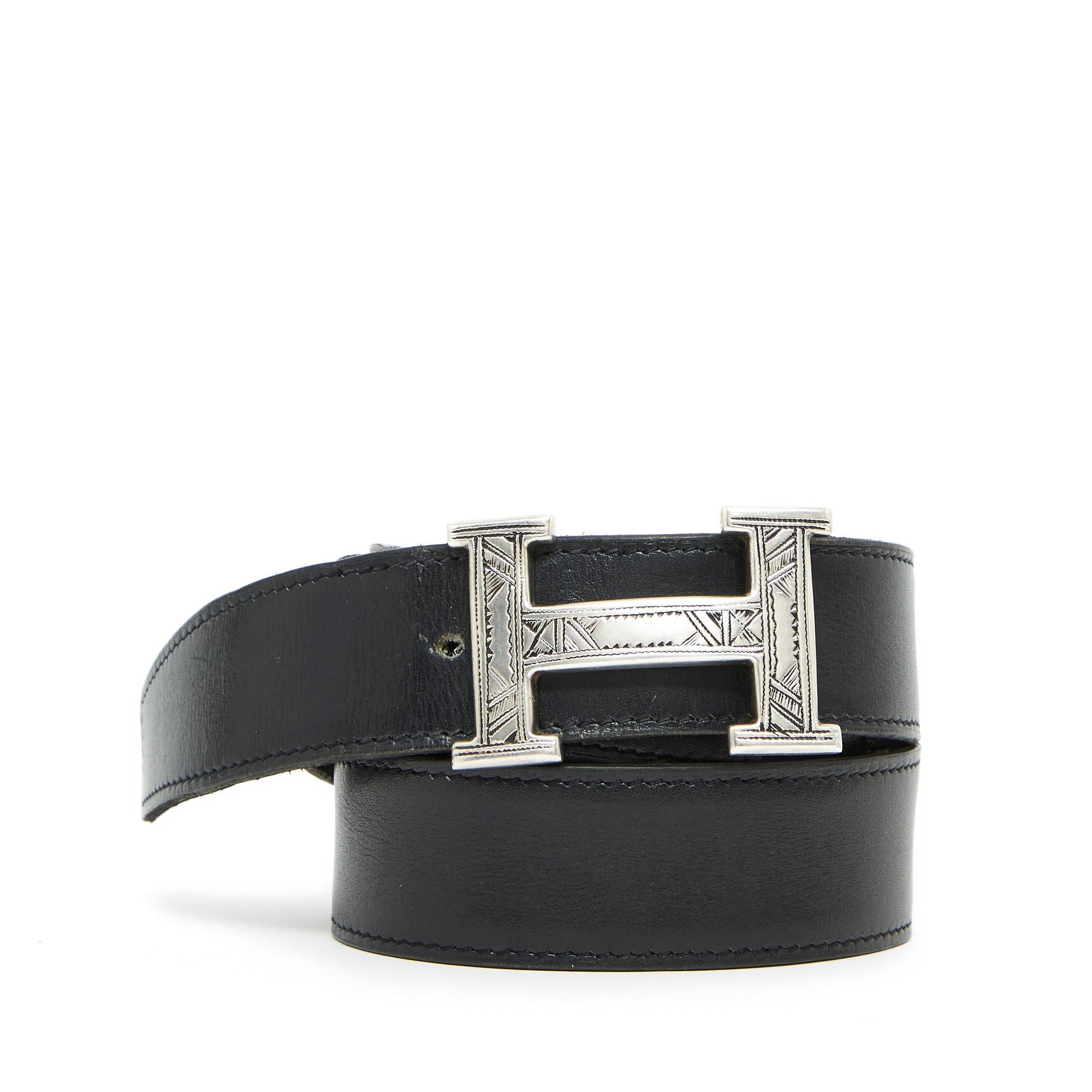 Hermès A series belt composed of a reversible leather link in black box leather and almost black brown grained leather, dated 2007, and an H or Constance buckle in solid silver decorated with Tuareg motifs, made by hand, and therefore unique. Link