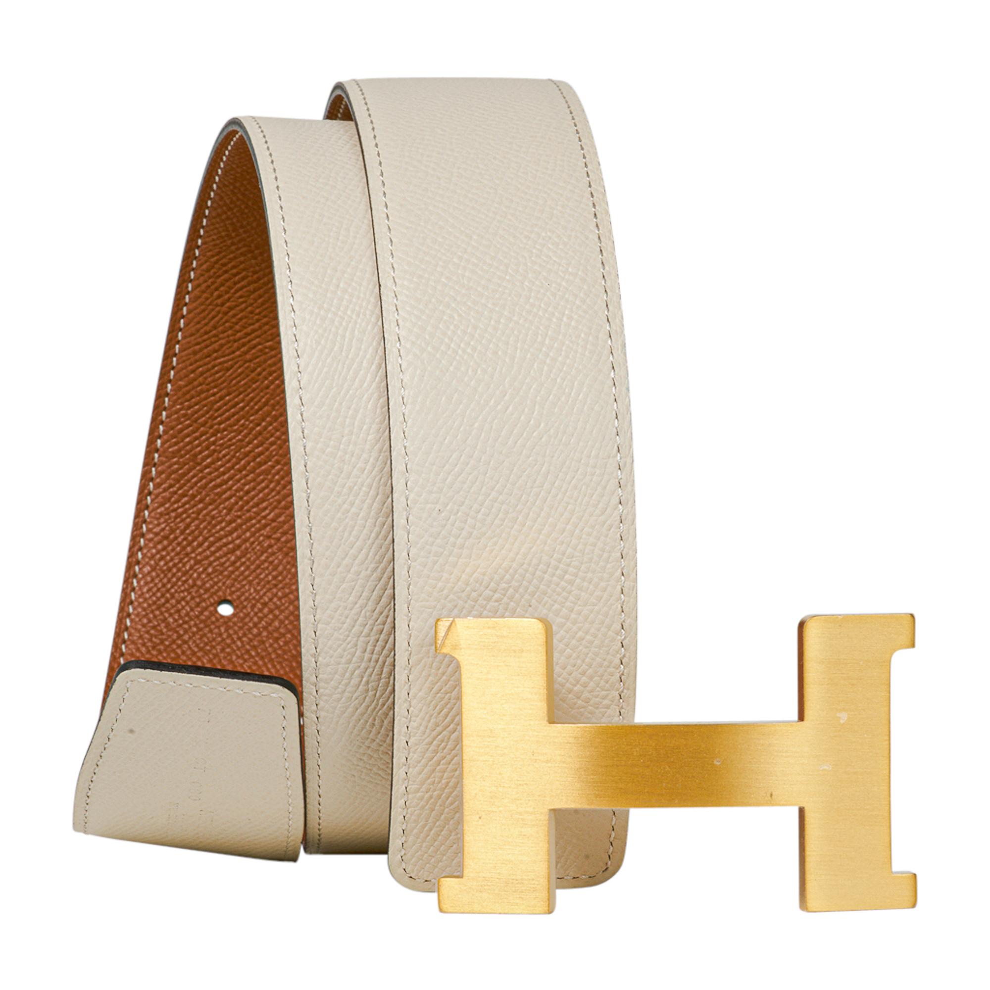 Guaranteed authentic Hermes Constance 42 mm belt features reversible Gold to Craie Epsom Leather.  
Fabulous over sized brushed Gold signature H buckle.  
Now a retired size, this is sure to become a collectors treasure. 
Signature HERMES PARIS MADE