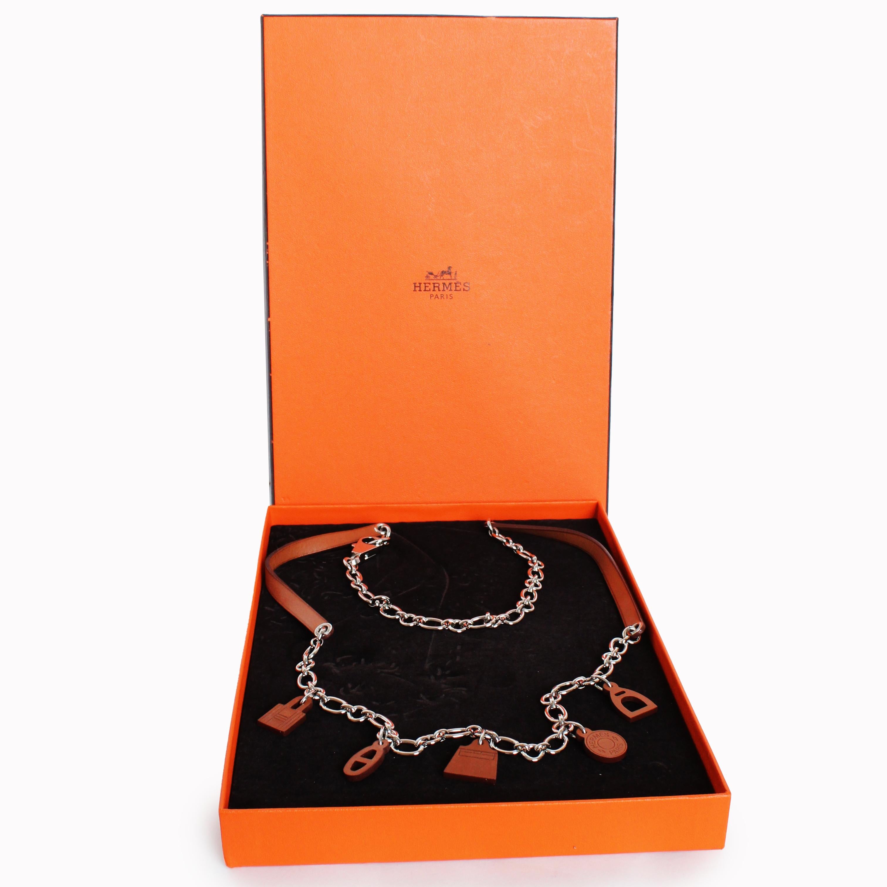 Incredibly chic 'Olga' belt from Hermes Paris, made in 2012.  The charms are made from Hermes Fauve Barenia leather, which patinas beautifully over time, and the chain and fastener is a shiny silver palladium.  

Fabulously chic and timeless- one
