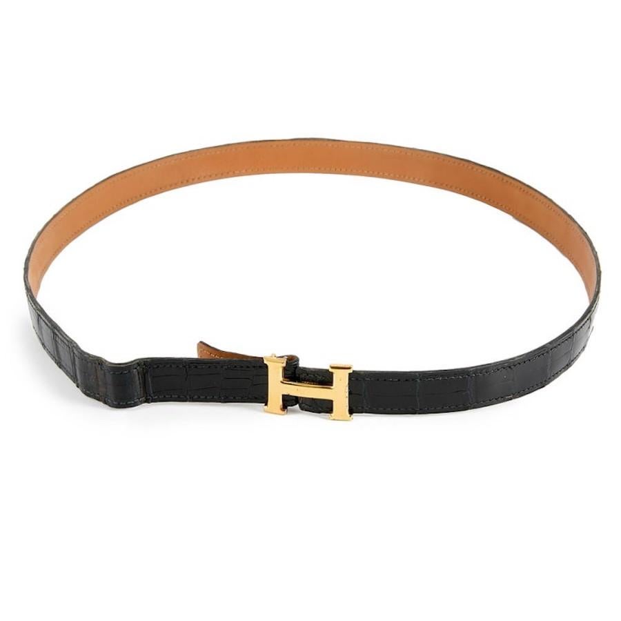 HERMES belt with golden H buckle. Vintage black thinny alligator belt. The Hermès buckle is in gold metal with micro stripes, Constance model. Made in France. The belt is not signed. It is 76 cm length and 1.7 cm high. It will be delivered in a
