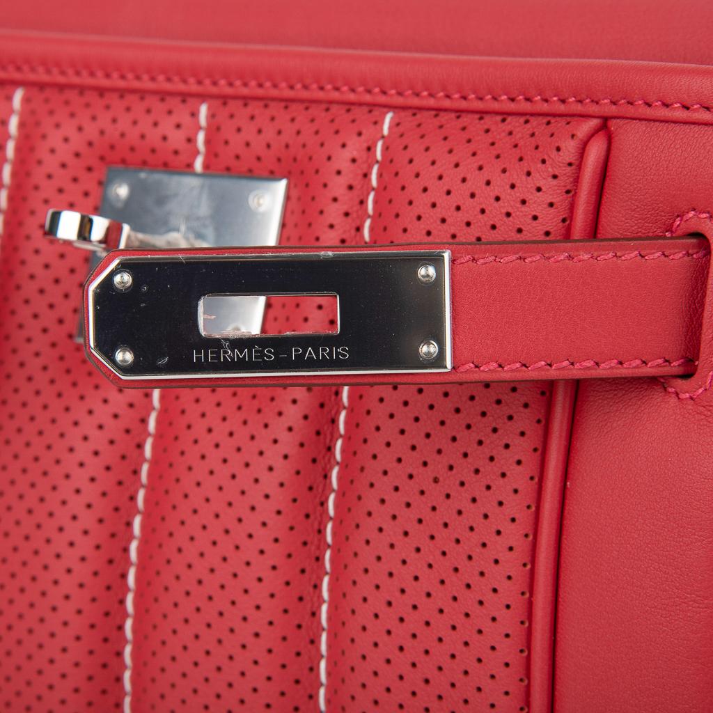 Guaranteed authentic Hermes mini Berline 21 bag featured in Vermillion. 
Beautiful in Swift leather and Palladium hardware.
The front shows a perforated sporty vertical quilted pattern below the signature Hermes hardware. 
The mini Berline 21 can be