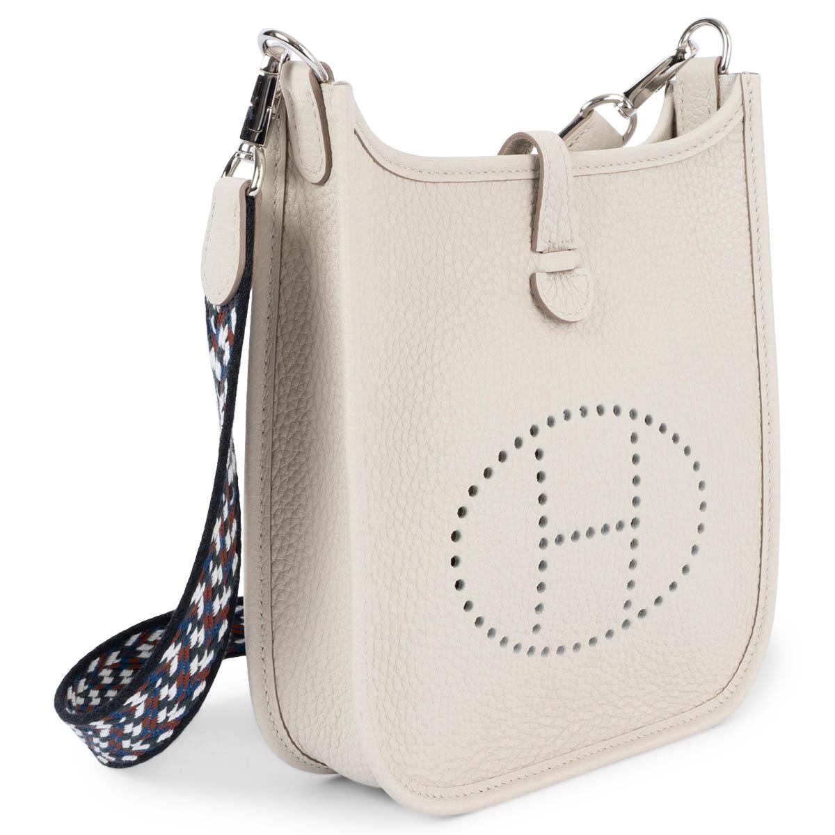 100% authentic Hermès Evelyne 16 TPM Crossbody Bag in Beton (pastel grey) Taurillon Clemence leather with a zigzag wool sangle strap in black and white, perforated leather 
