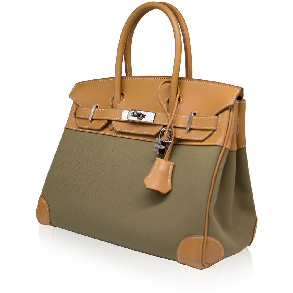 Adding a twist to the traditional Hermès Birkin, this highly collectable rarity combines contrasting panels of cognac leather and toile and is accented with silver-toned hardware, white stitching and the brand's iconic twist-lock fastening. The