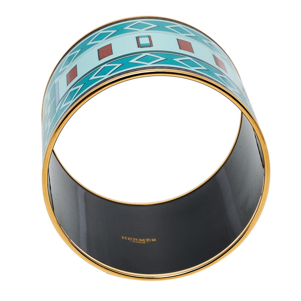 Hermes presents this stylish and chic enamel bracelet. It features a print throughout inspired by the house's iconic Collier De Chien bracelet. Hallmark details on the inside bring this creation to completion.

Includes: Original Dustbag, Original
