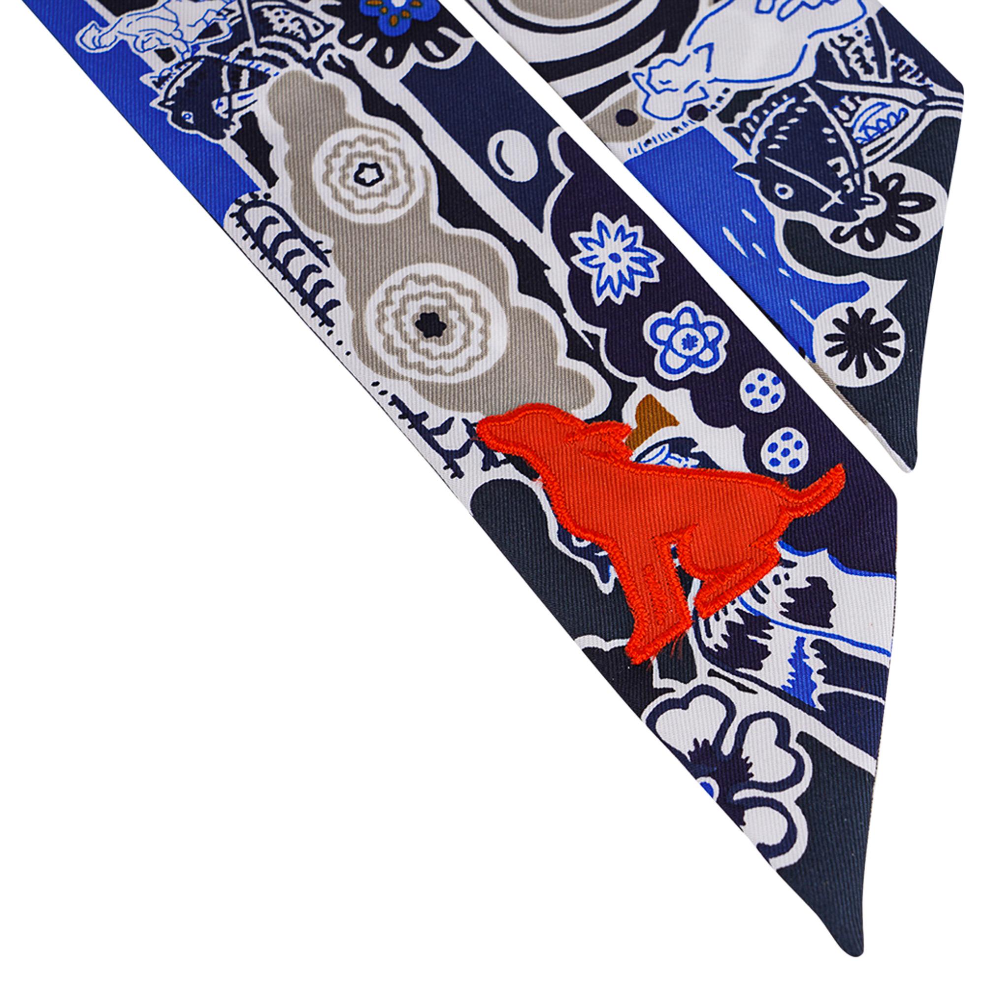 Mightychic offers an Hermes limited edition Twilly features Bingata Sticker in Marine, Tabac, Bleu Vif.
A silk orange sitting dog shaped patch adds a bit of whimsy.
Sewn with satin stitch.
This iconic Hermes accessory can be worn in a myriad ways to