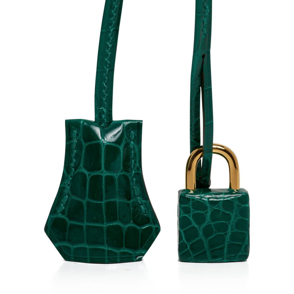 Guaranteed authentic Hermes Birkin 25 crocodile bag features jewel toned Emerald Green.
Lush with gold hardware. 
This divine jewel and easily moves from day to night.
NEW or NEVER WORN  
Comes with the lock and keys in the clochette, signature