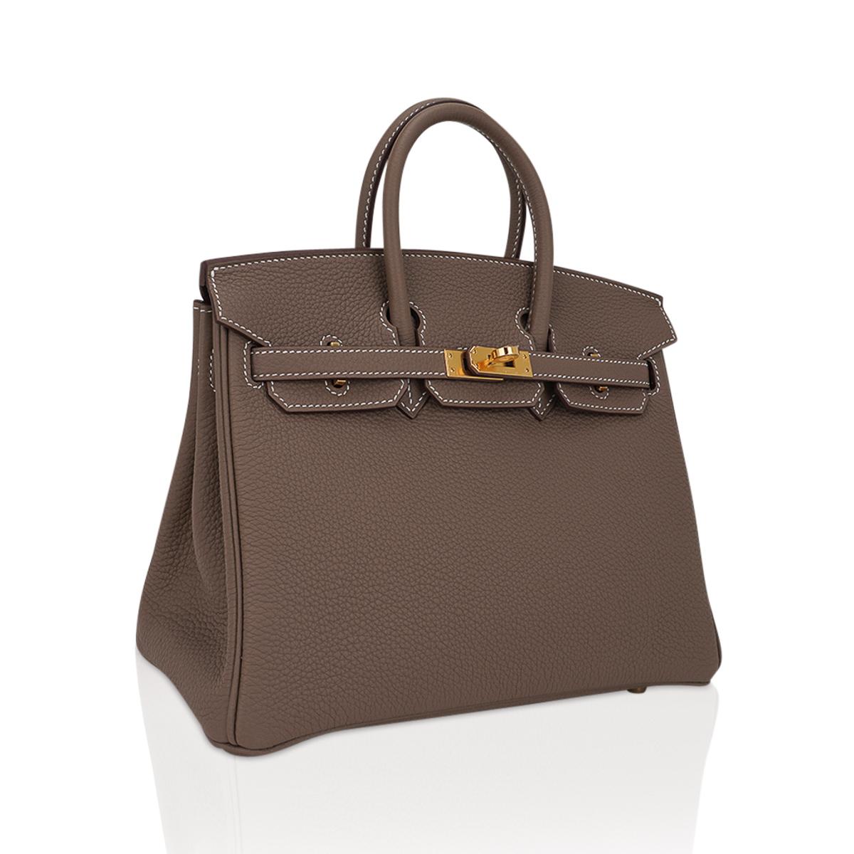 Mightychic offers an Hermes Birkin 25 bag featured in coveted neutral Etoupe. 
Signature bone top stitch detail. 
Lush Togo leather is supple and scratch resistant.
Rich with gold hardware.
Comes with lock, keys, clochette, sleepers, raincoat,