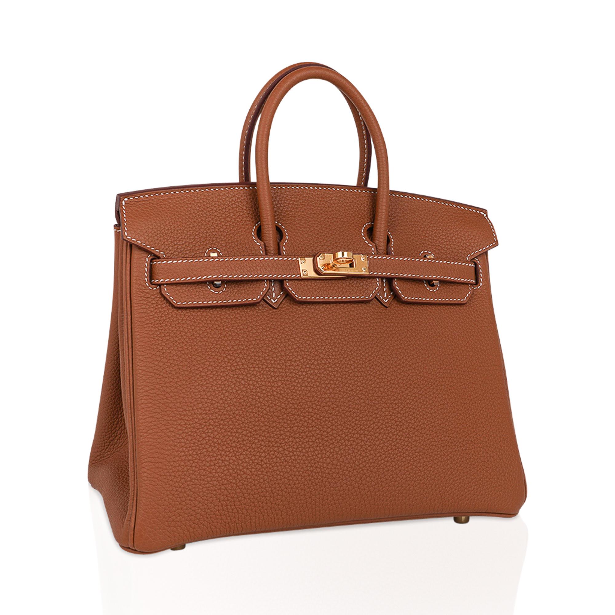 Mightychic offers an Hermes Birkin 25 bag featured in classic Gold.
This neutral Hermes Birkin is the all time perfect neutral statement.
Signature bone top stitch detail.
Lush Togo leather is supple and scratch resistant.
Rich with gold