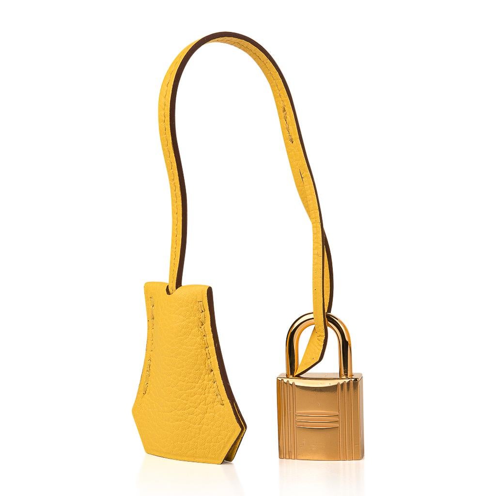 Guaranteed authentic Hermes Birkin 25 bag features Jaune de Naples in Novillo leather. 
Bull leather, Taurillion Novillo has a far finer grain than Clemence or togo, and is lighter in weight.
Colours have rich saturation and colours are clear with
