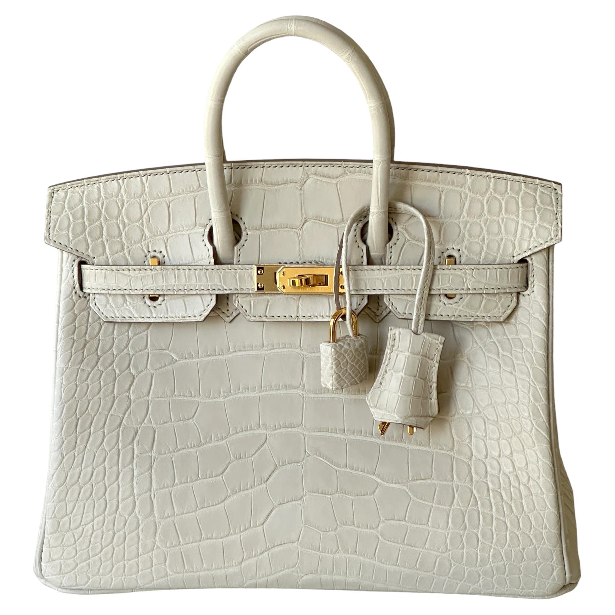 Hermes
Matte Alligator
Birkin 25 cm
Gold Hardware
This Birkin is in  Beton matte Mississippienis alligator leather with gold hardware and has tonal stitching, front strap, two straps with center toggle closure, clochette with lock and two keys and