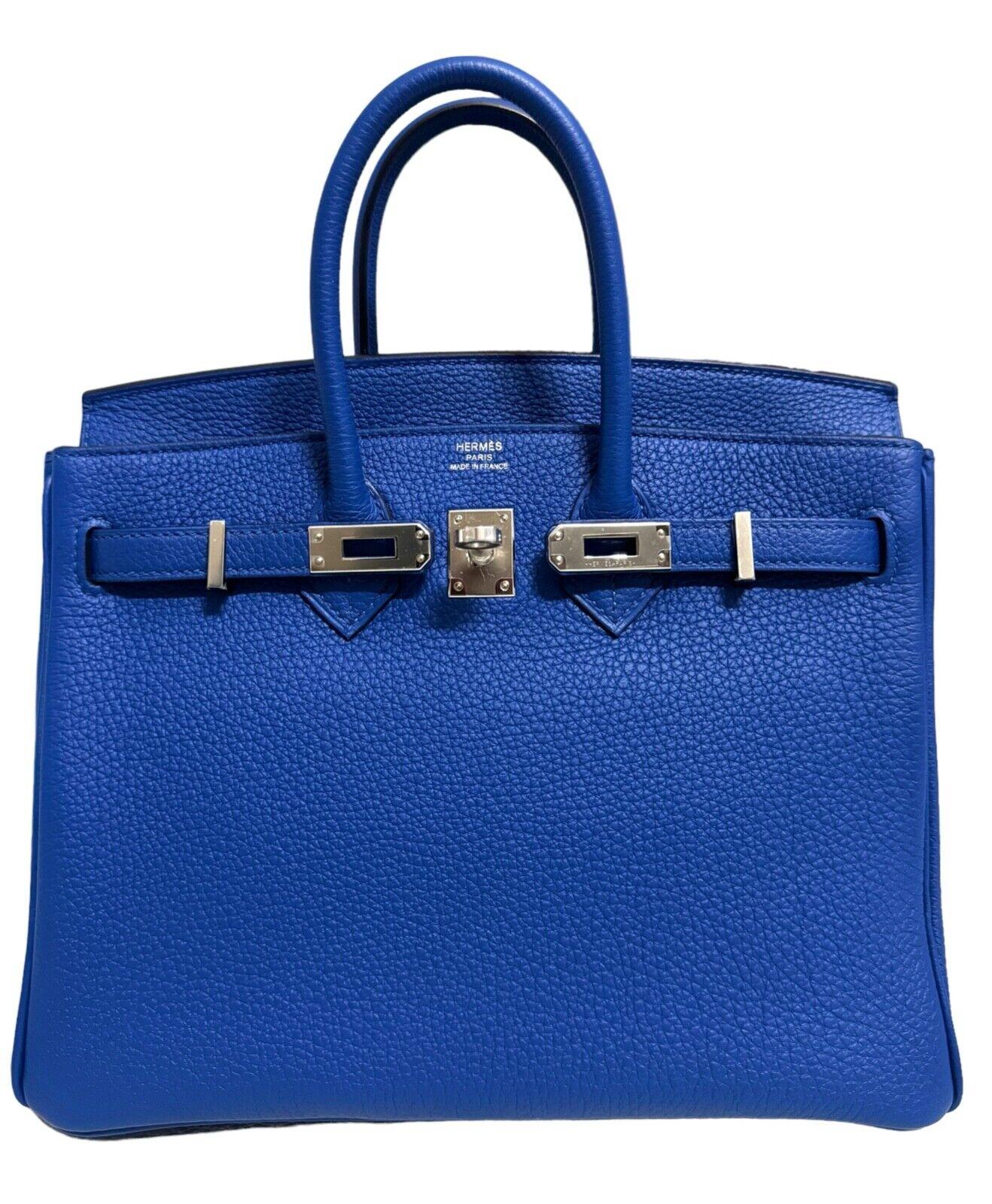 Absolutely Rare Stunning Highly Coveted Pristine Hermes Birkin 25 Blue Royal Togo Leather complimented by Palladium Hardware. As New Condition Plastic on Hardware, excellent structure and corners. From Collectors Closet. 

Shop with Confidence from