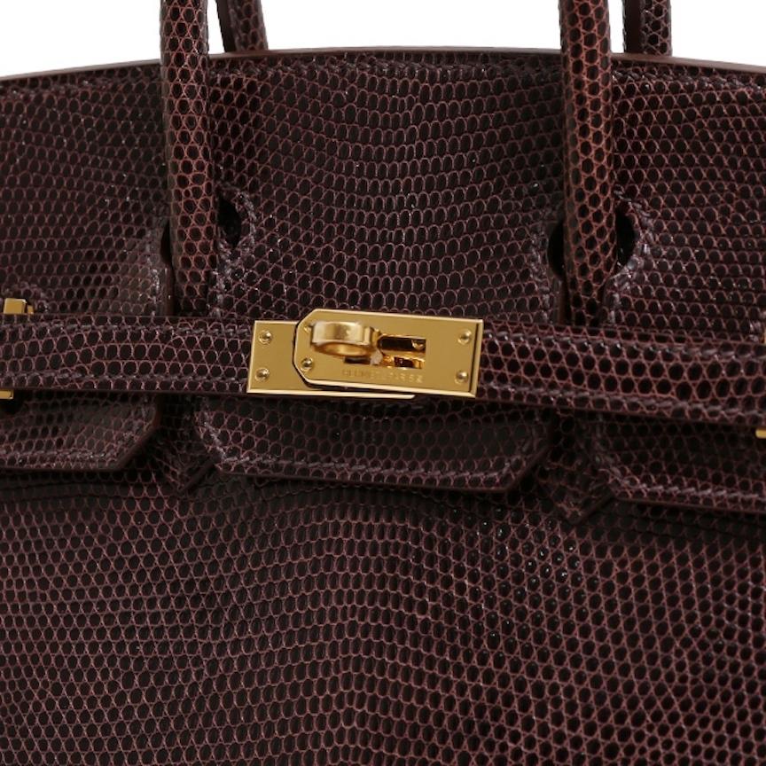 A Rare Find That Will Last A Lifetime.

Luxurious exotic lizard skin adorns this beautiful Hermes Birkin 25.  Featuring shiny, rich brown skin and stunning gold tone hardware, it’s a strikingly beautiful combination that will endure.  Authenticity