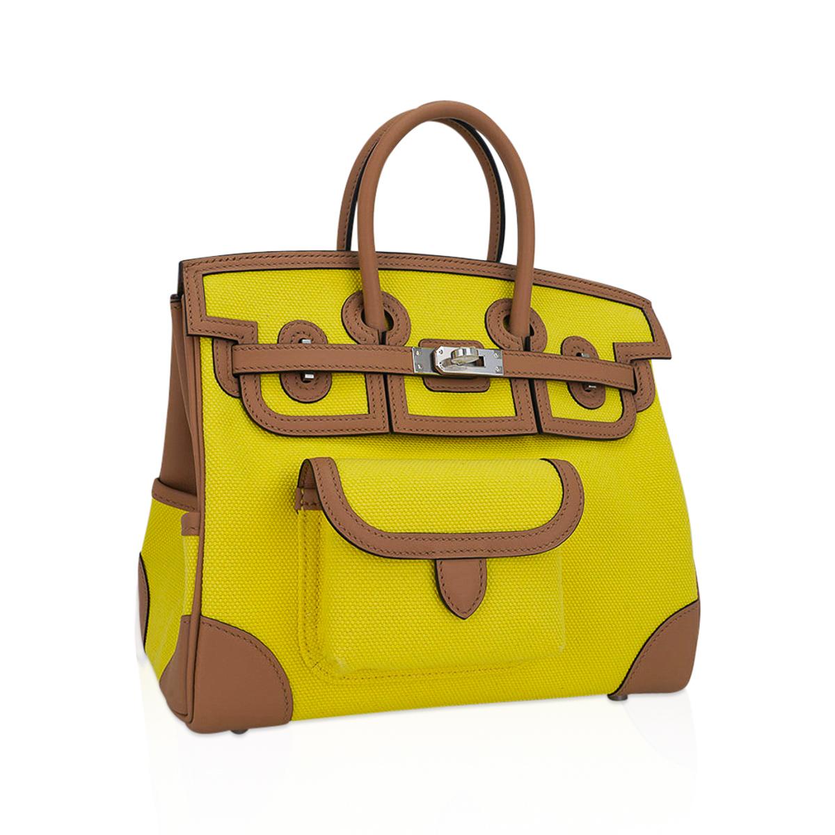 Mightychic offers an Hermes Cargo Birkin 25 bag featured in Jaune Citron and Chai.
This Hermes very limited edition utility Birkin bag is created with Goeland canvas and Swift leather trim.
Includes front and rear snap pockets, exterior credit card