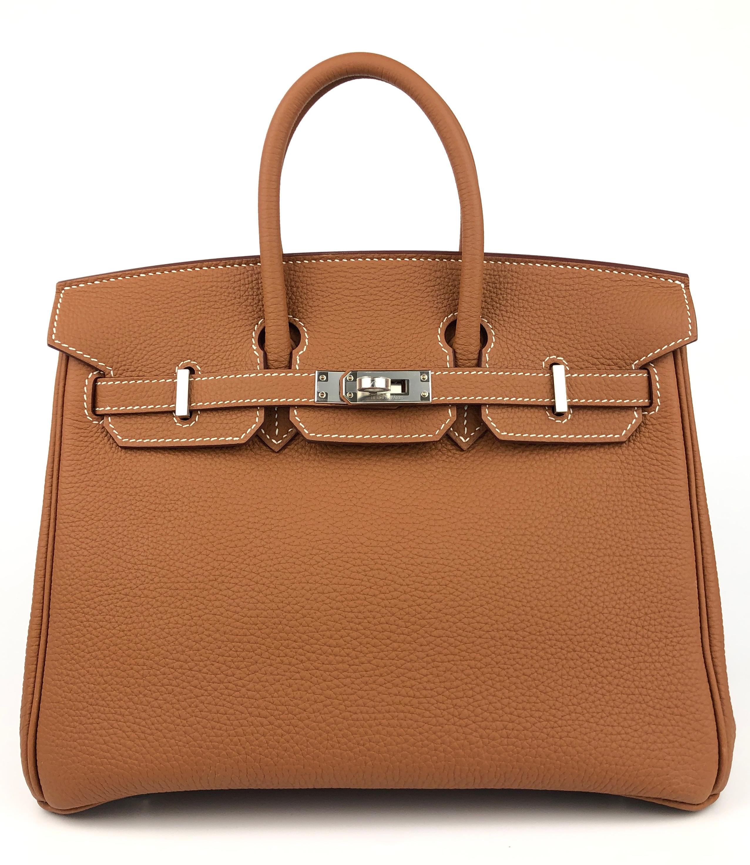 Absolutely Stunning and One The Most Coveted and Difficult to get Hermes Combos! As New 2021 Hermes Birkin 25 Gold Togo Leather complimented by Palladium Hardware. As New Plastic on all Hardware and Feet. Z Stamp 2021. Please Note, the bag has minor