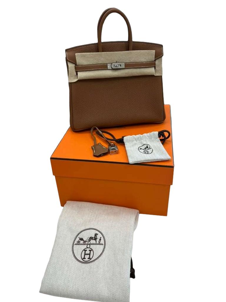 This Birkin is in Gold Togo leather with palladium hardware and features contrast stitching, front flap, two straps with center toggle closure, a clochette with lock and two keys, and double rolled handles. The interior is lined with Gold chevre and