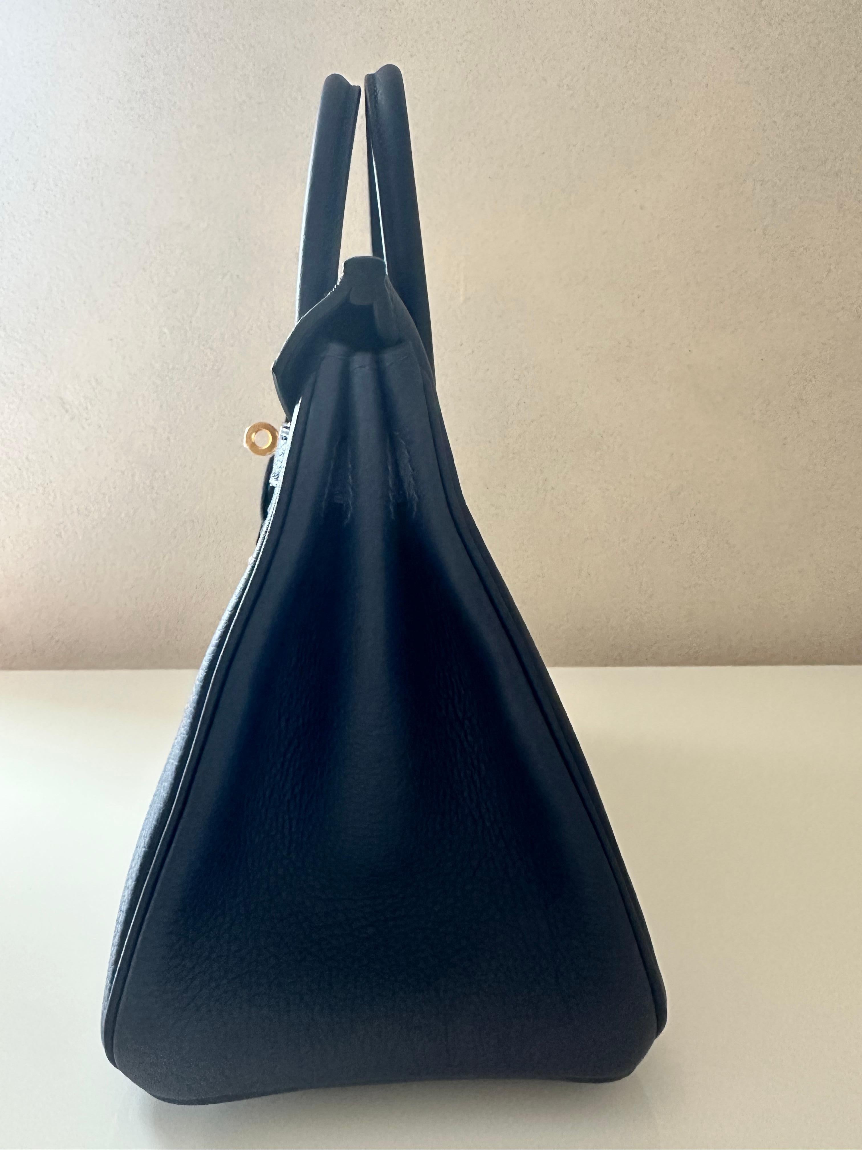 Hermès Birkin 25 in Bleu Abysse (new 2025 color) Togo leather, a classic piece in a rich, deep navy blue. Crafted from durable textured togo leather and golden hardware. 
This Hermès Birkin 25 is in brand new condition and comes with protective