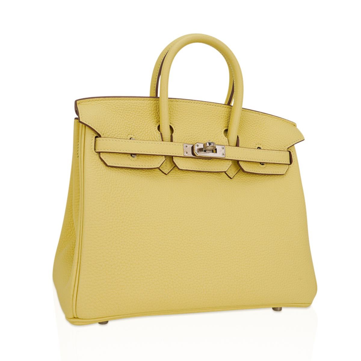 Mightychic offers an  Hermes Birkin 25 bag featured in gorgeous Jaune Poussin.
Togo leather with fresh palladium hardware.
This gentle pale yellow is lovely twist on a neutral Hermes Birkin bag.
Comes with lock, keys, clochette, sleepers, raincoat,