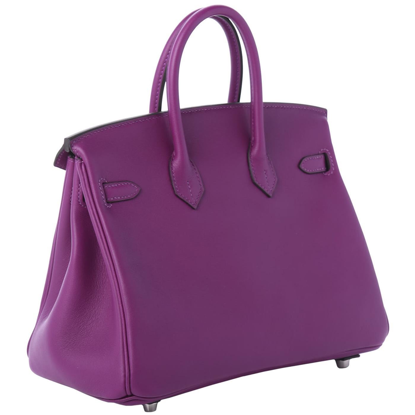 This is an authentic HERMES Swift Birkin 25 in Anemone. This classic handbag is beautifully crafted of supple swift leather with a fine grain in purple. The bag features rolled leather top handles, a frontal flap and strap closure and palladium
