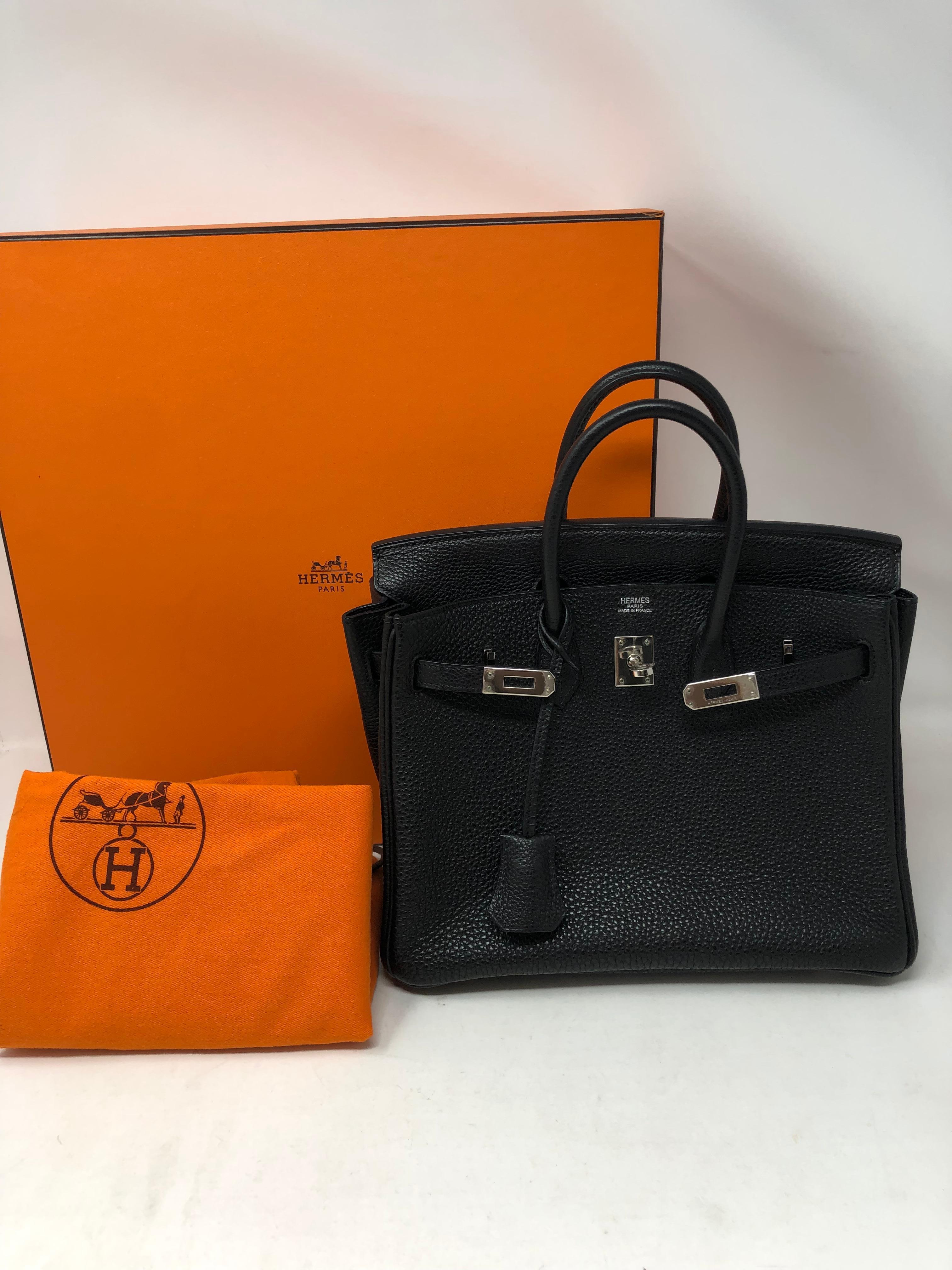 Hermes Birkin 25 Black Togo Leather Bag. Mint condition like new. Palladium hardware. Plastic is still on hardware. The most highly coveted Birkin bag. The size is the rarest of all. Considered the unicorn of Hermes bags. Includes rain jacket, dust