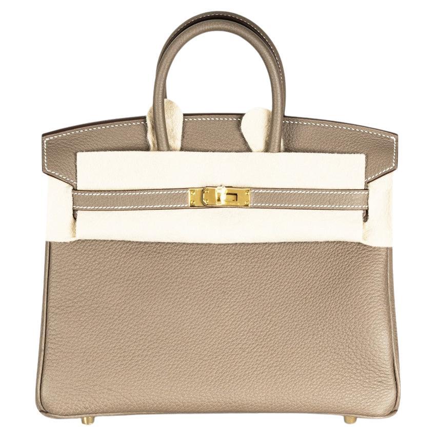 An amazing Hermès Birkin 25cm handbag. The exterior of this Birkin is crafted in soft grained Togo leather with white stitching.  It features gold tone hardware with two straps and a front toggle closure. The interior, lined in Togo leather, has a