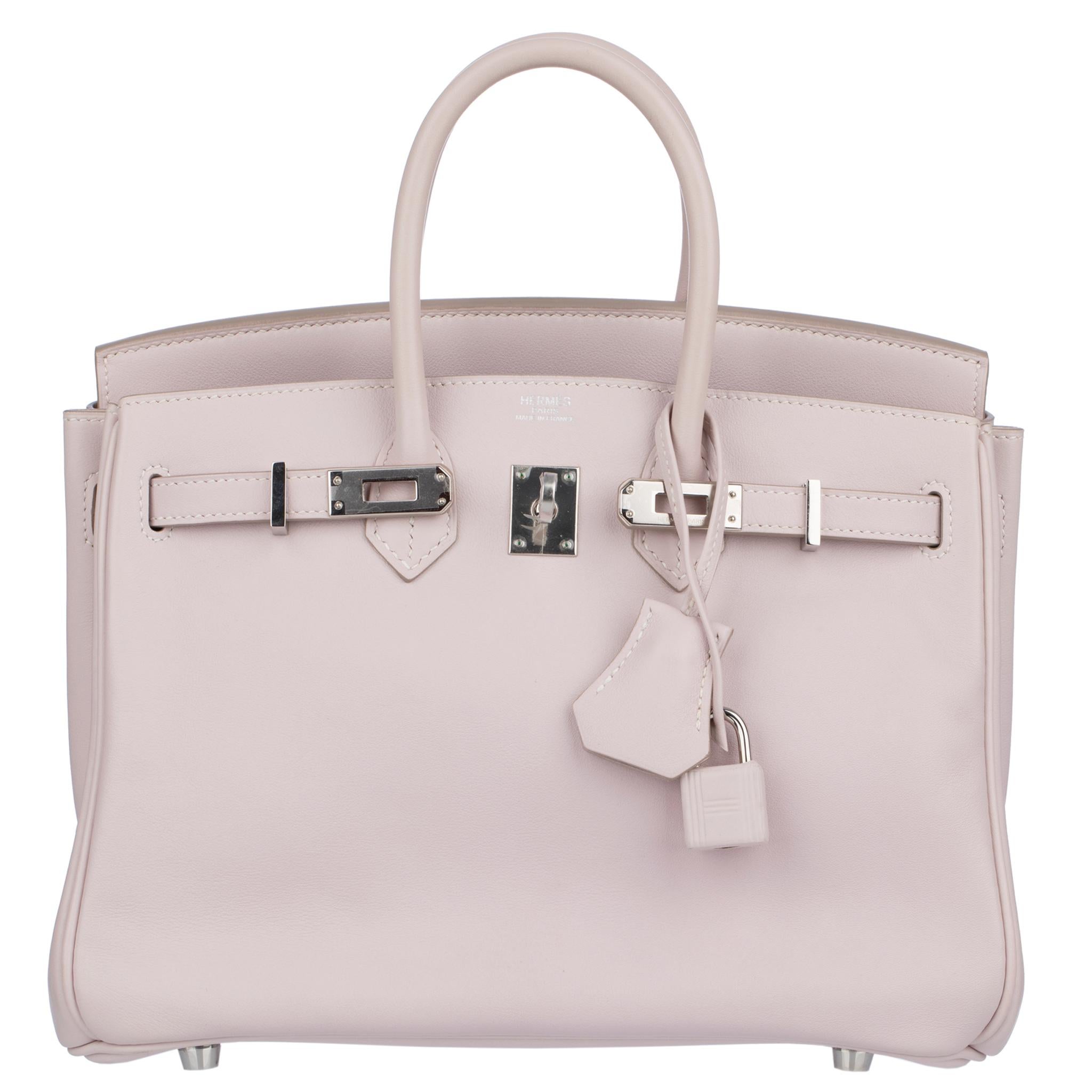 The Hermes Birkin 25cm in Rose Dragee Swift Leather with Palladium Hardware is an embodiment of timeless elegance and grace.

Meticulously crafted by Hermes artisans, this iconic bag features the exquisite Rose Dragee Swift Leather, known for its