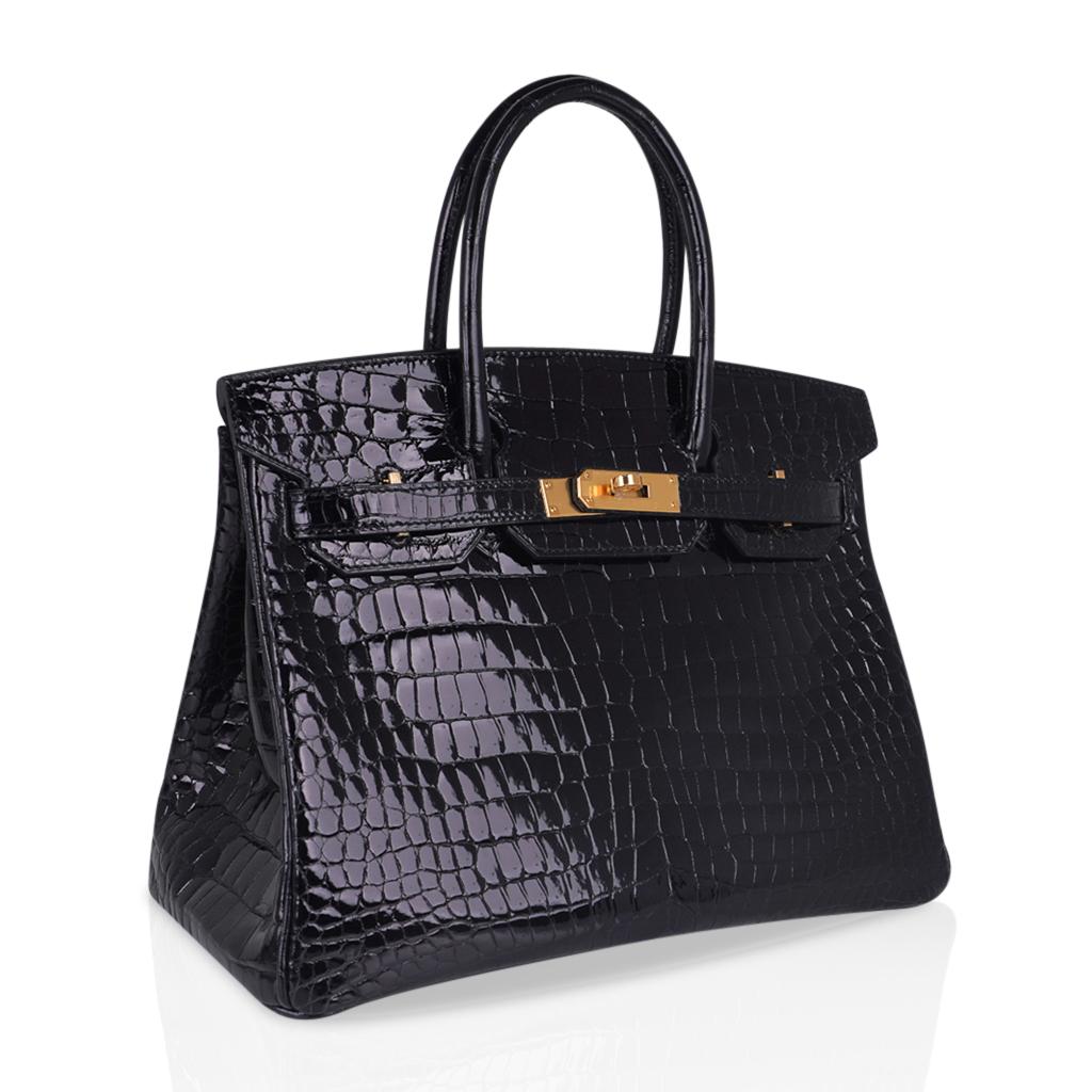 Mightychic offers an Hermes Birkin 30 bag featured in classic, rich Black Porosus Crocodile.
Beautiful scales accentuated with gold hardware.
This exotic Hermes Birkin beauty moves easily from day to evening.
NEW or NEVER WORN
Comes with the lock