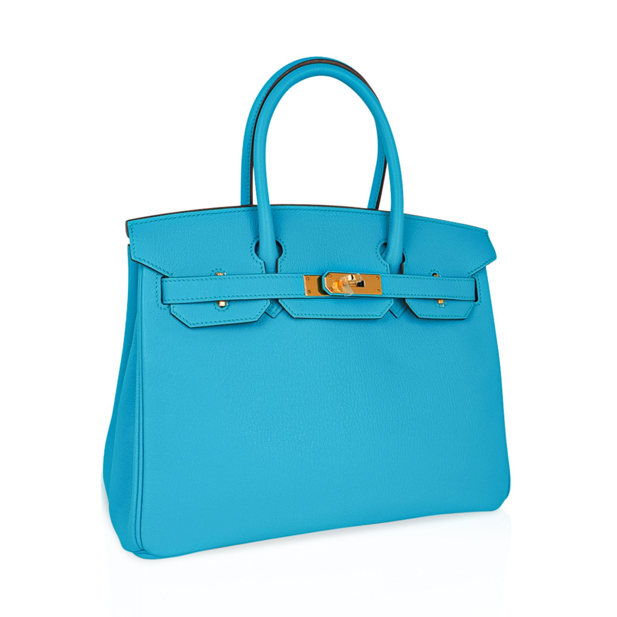 Mightychic offers an Hermes Birkin 30 bag featured in coveted Blue Aztec.
This stunning rare colour is considered to be among the most gorgeous of all Hermes Blue hues.
Chevre leather accentuates the beauty of Hermes colours.
Lush with gold
