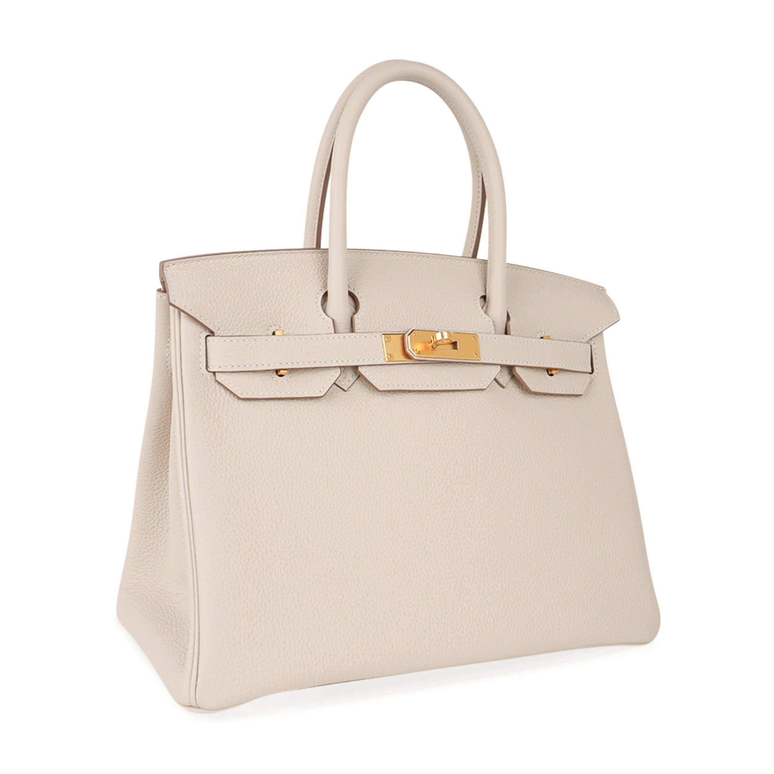 Mightychic offers an Hermes Birkin 30 bag featured in neutral Craie with Gold hardware.
This beautiful combination is timeless.
Togo leather is supple and scratch resistant.
Craie is one of the most in demand neutral colours and beloved by Hermes