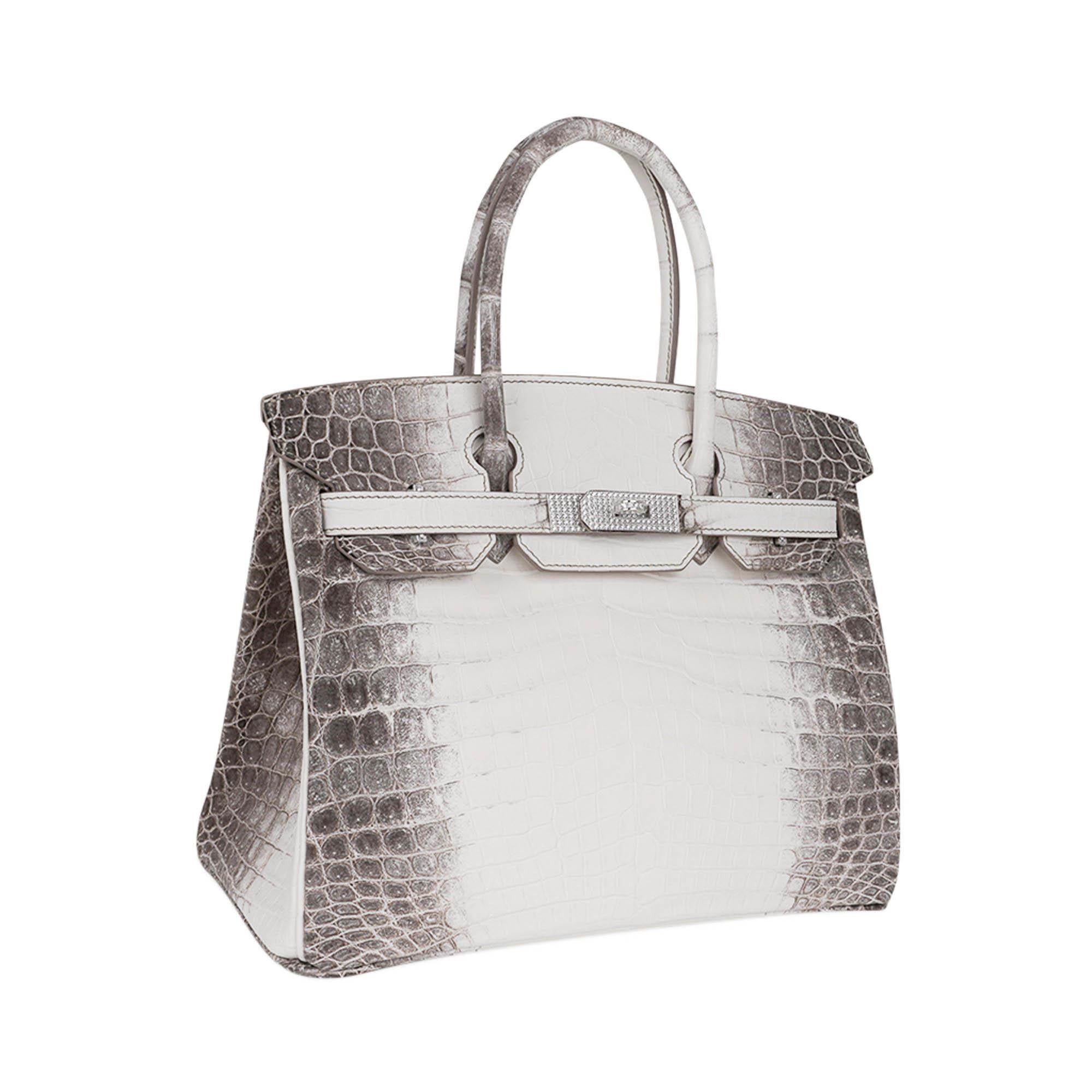 Mightychic offers an exceptional Hermes Birkin 30 Diamond Blanc Himalaya Matte Crocodile.
Exquisite coloration and details, this rare and coveted bag is becoming more elusive and difficult to find.
18K White Gold hardware set with 245