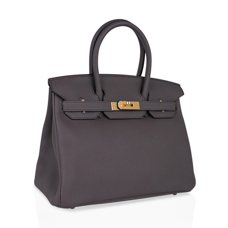 Mightychic offers an Hermes Birkin 30 bag featured in coveted Etain Gray with lush gold hardware. 
Neutral perfection in togo leather.
NEW or NEVER WORN
Comes with the lock and keys in the clochette, sleepers, raincoat and signature Hermes box.