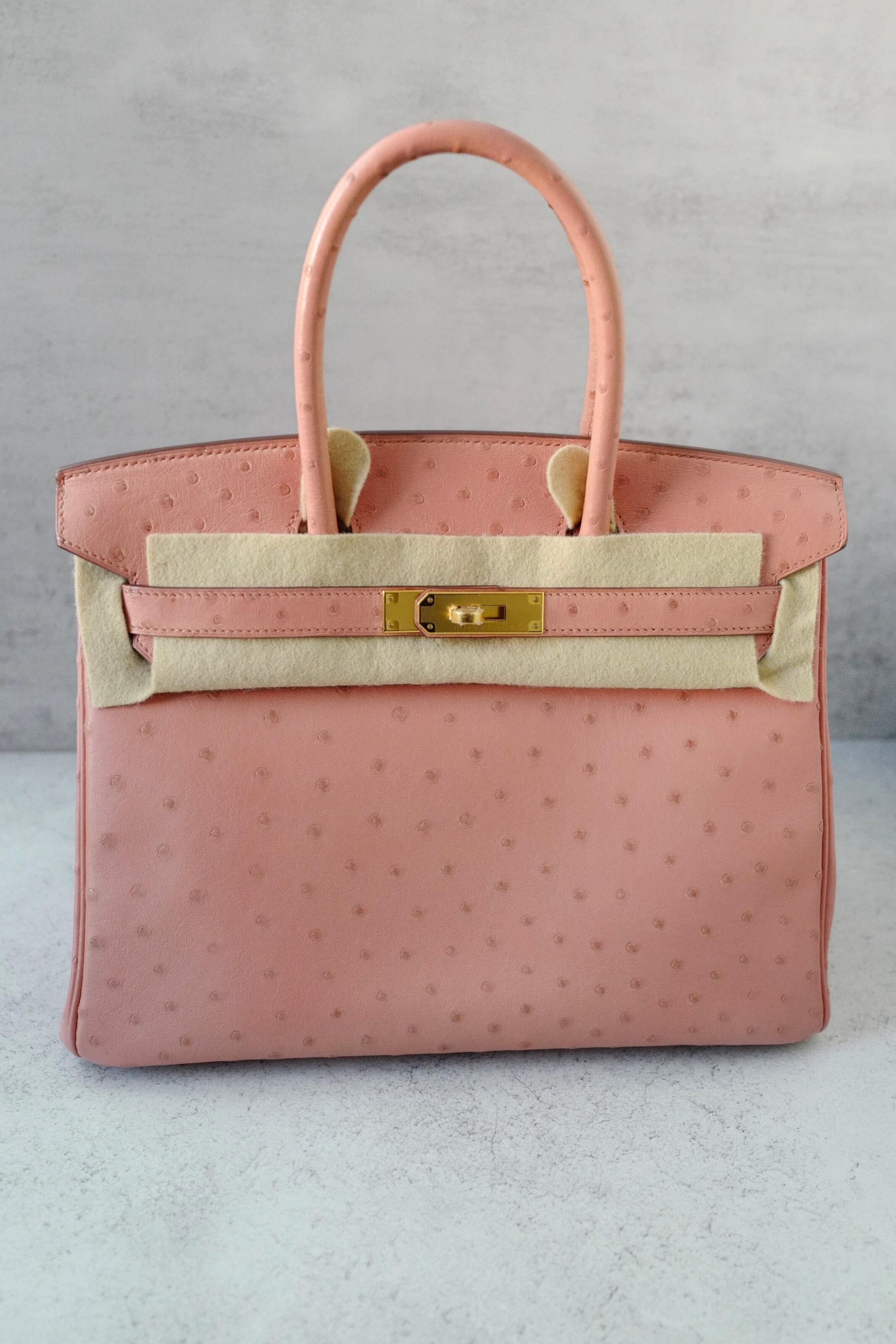 The Hermès Birkin 30 Ostrich Terre Cuite with Gold Hardware is a masterpiece of timeless craftsmanship and exotic elegance. Expertly handcrafted from luxurious ostrich leather, it showcases the distinctive dotted pattern that gives the material its