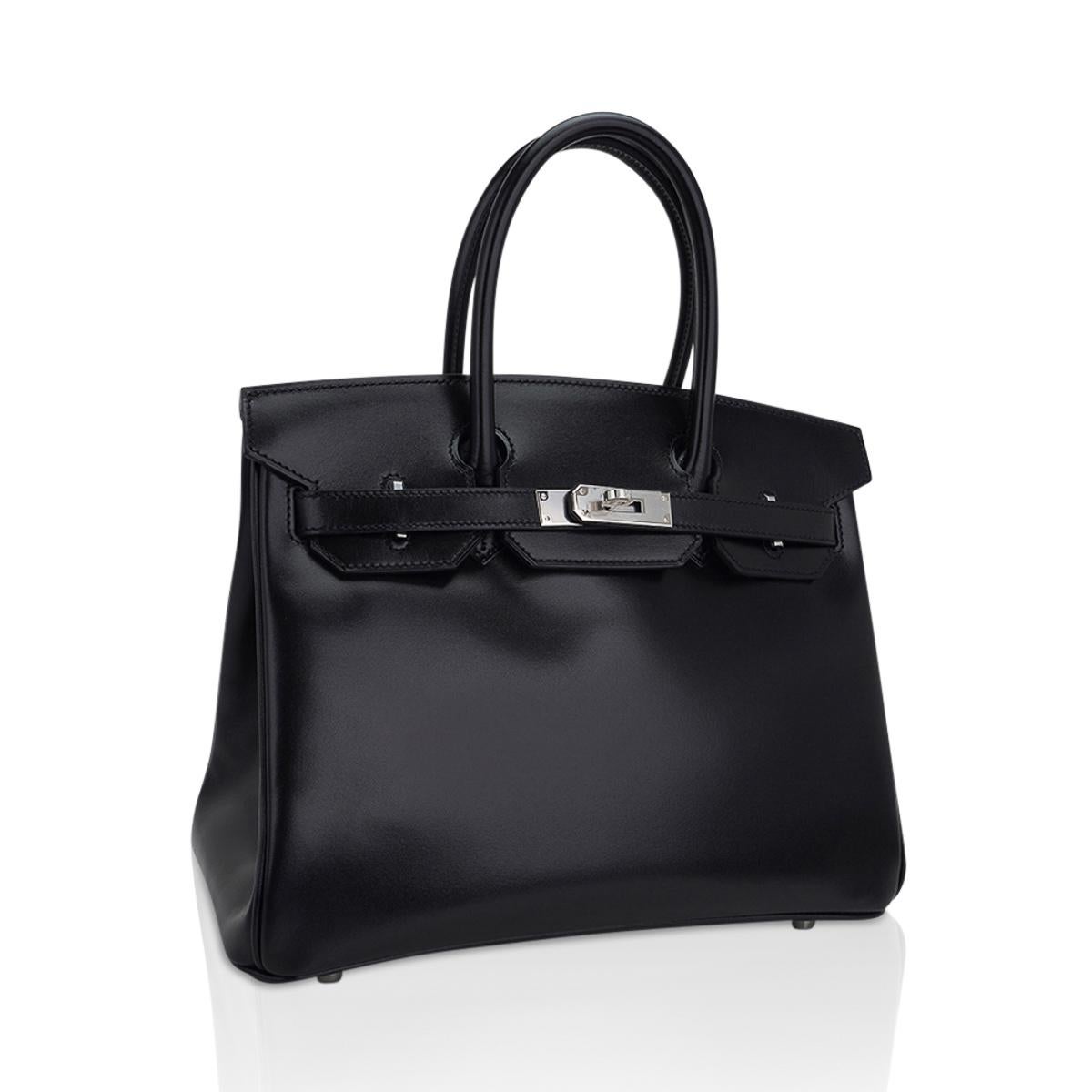 Mightychic offers an Hermes Birkin 30 bag featured in very rare and coveted Black box leather.
Being the original leather for Hermes bags, Box leather has retained its provenance and heritage and is among the most special addition to any