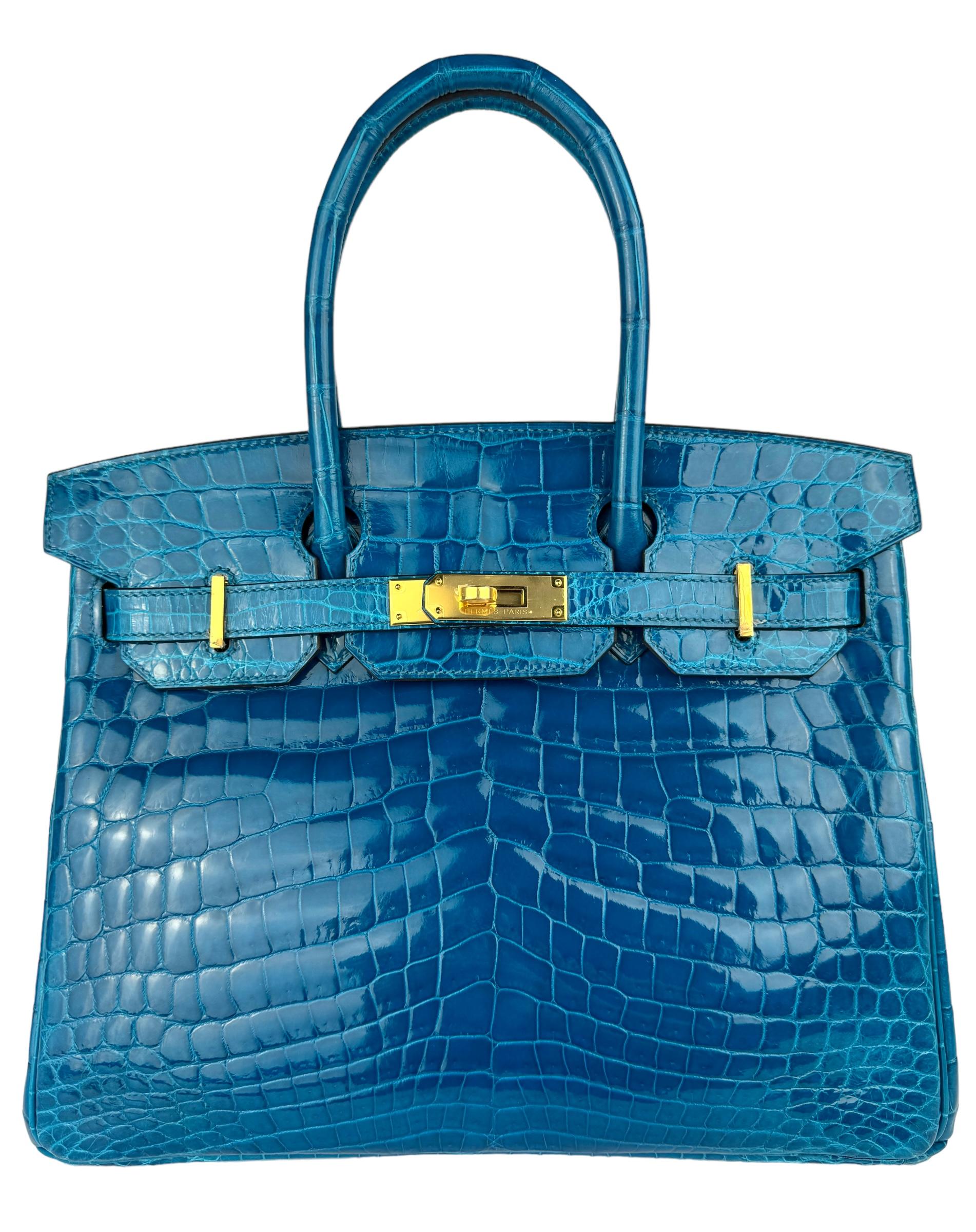 Absolutely Stunning RARE Collectors Piece. Hermes Birkin 30 Blue Izmir Niloticus Crocodile Leather. Complimented by Gold Hardware. Pristine Condition, Plastic on hardware, excellent structure and corners. 2015 T Stamp. BEST PRICE ON THE MARKET!