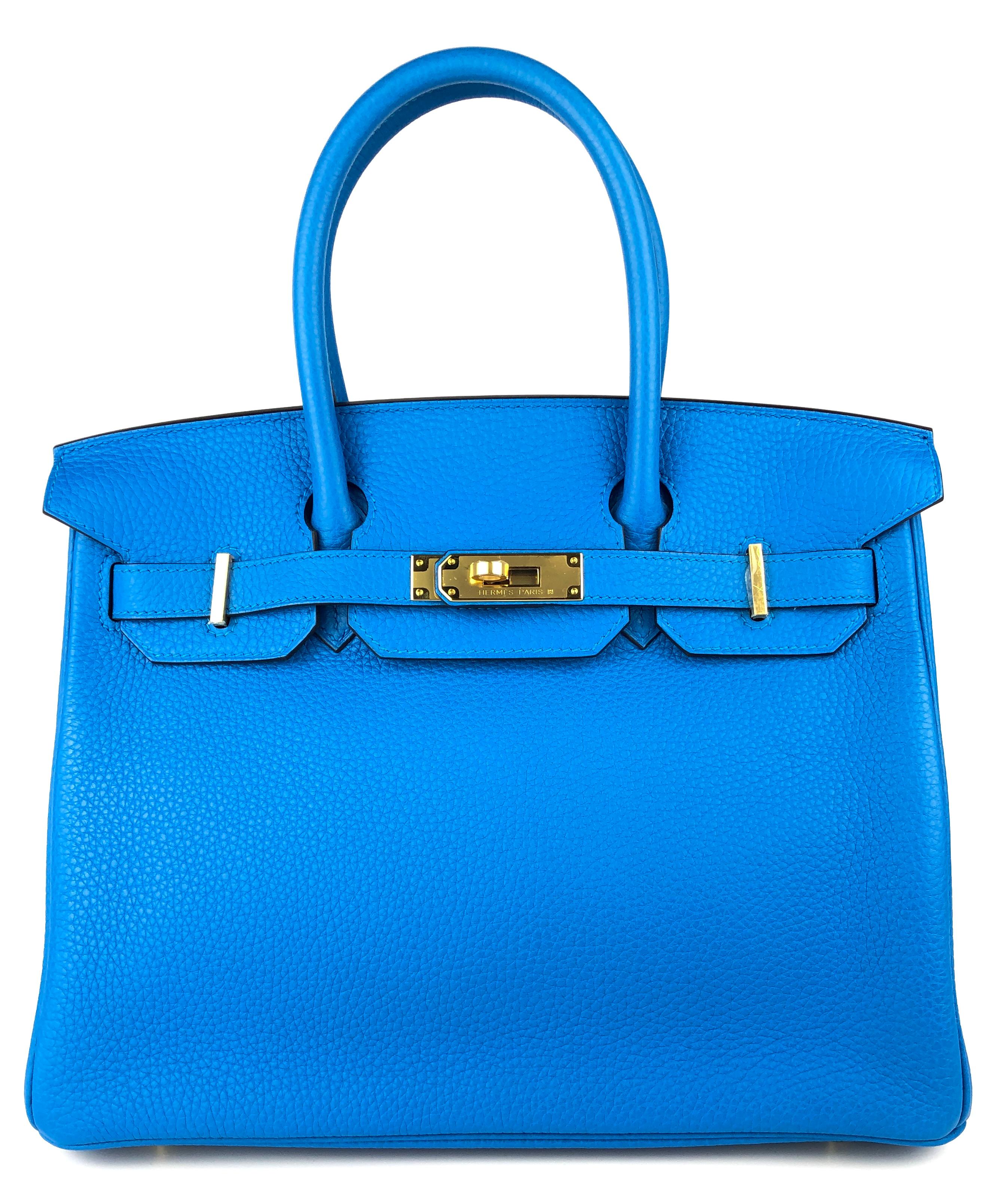 Ultra Rare Absolutely Stunning Hermes Birkin 30 Blue Zanzibar Togo Leather, Complimented by Gold Hardware. Pristine Condition with Plastic on all Hardware. Only Carried 2 Times! 

Please keep in mind that this is a pre owned item, the bag has been