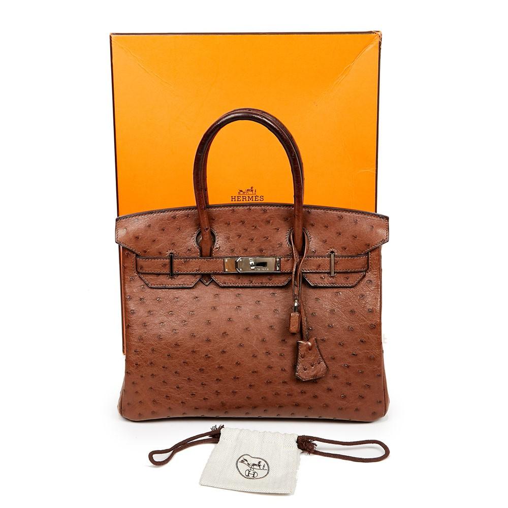Sublime Birkin 30 Hermes made of ostrich in tobacco color . The jewelry is in silver palladium metal. It is signed 