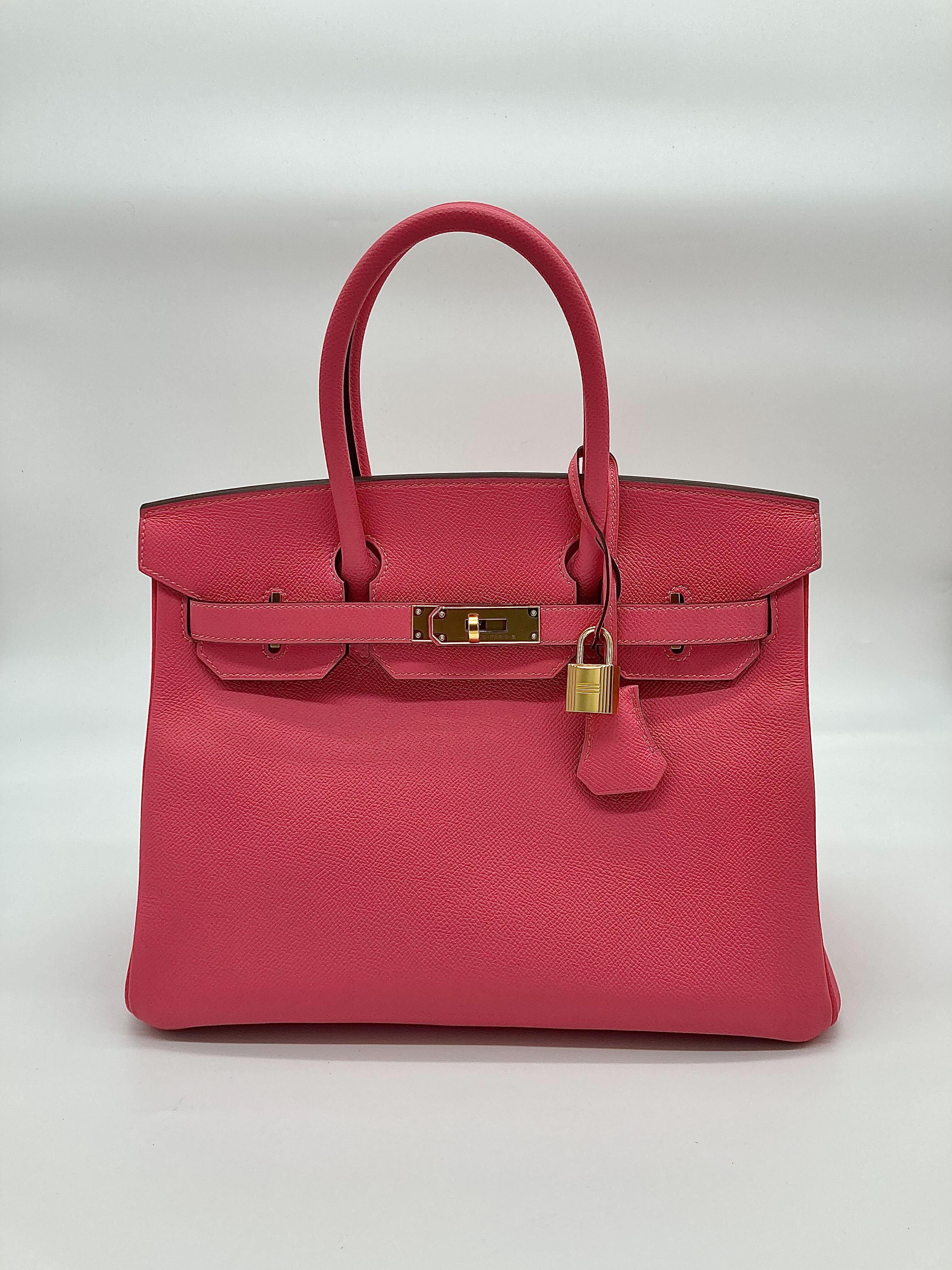 Jewels Aficionado offers an Hermès 8W Rose Azalee Birkin 30 in Epsom leather that is a refined and elegant piece. Its soft pink hue adds a touch of femininity, while Epsom leather ensures durability and a structured silhouette. Finished with gold