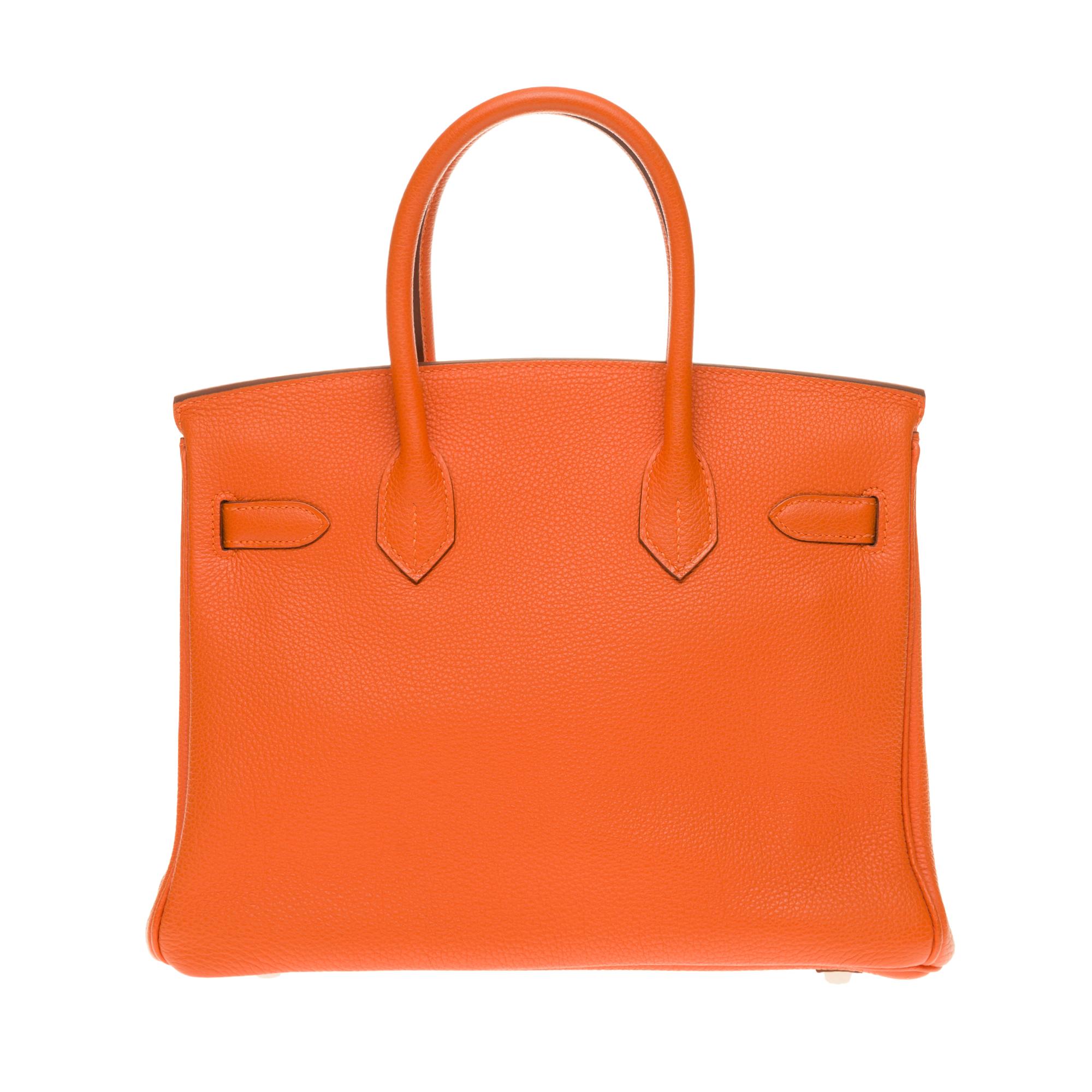 Exceptional Hermes Birkin handbag 30 cm in orange Togo leather, palladium metal hardware, orange stitching, double orange leather handle allowing a handheld

Closure by flap
Orange leather inner lining, one zipped pocket, one patch pocket
Sold with