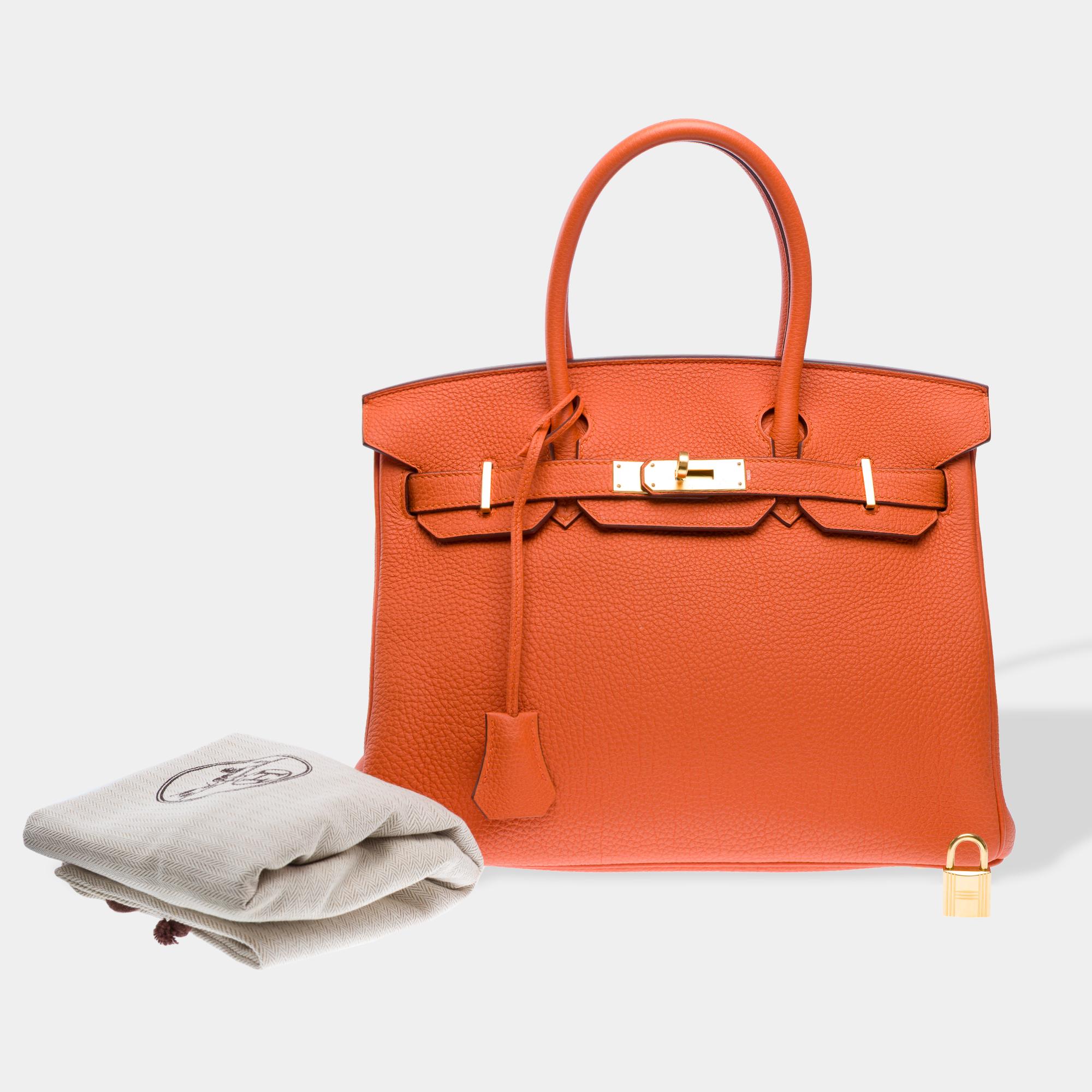 Beautiful​ ​and​ ​Bright​ ​Hermes​ ​Birkin​ ​30​ ​handbag​ ​in​ ​Orange​ ​Togo​ ​calf​ ​leather,​ ​with​ ​gold​ ​metal​ ​hardware,​ ​double​ ​orange​ ​leather​ ​handles​ ​allowing​ ​hand​ ​carry

Closure​ ​with​ ​flap
Orange​ ​leather​ ​interior​