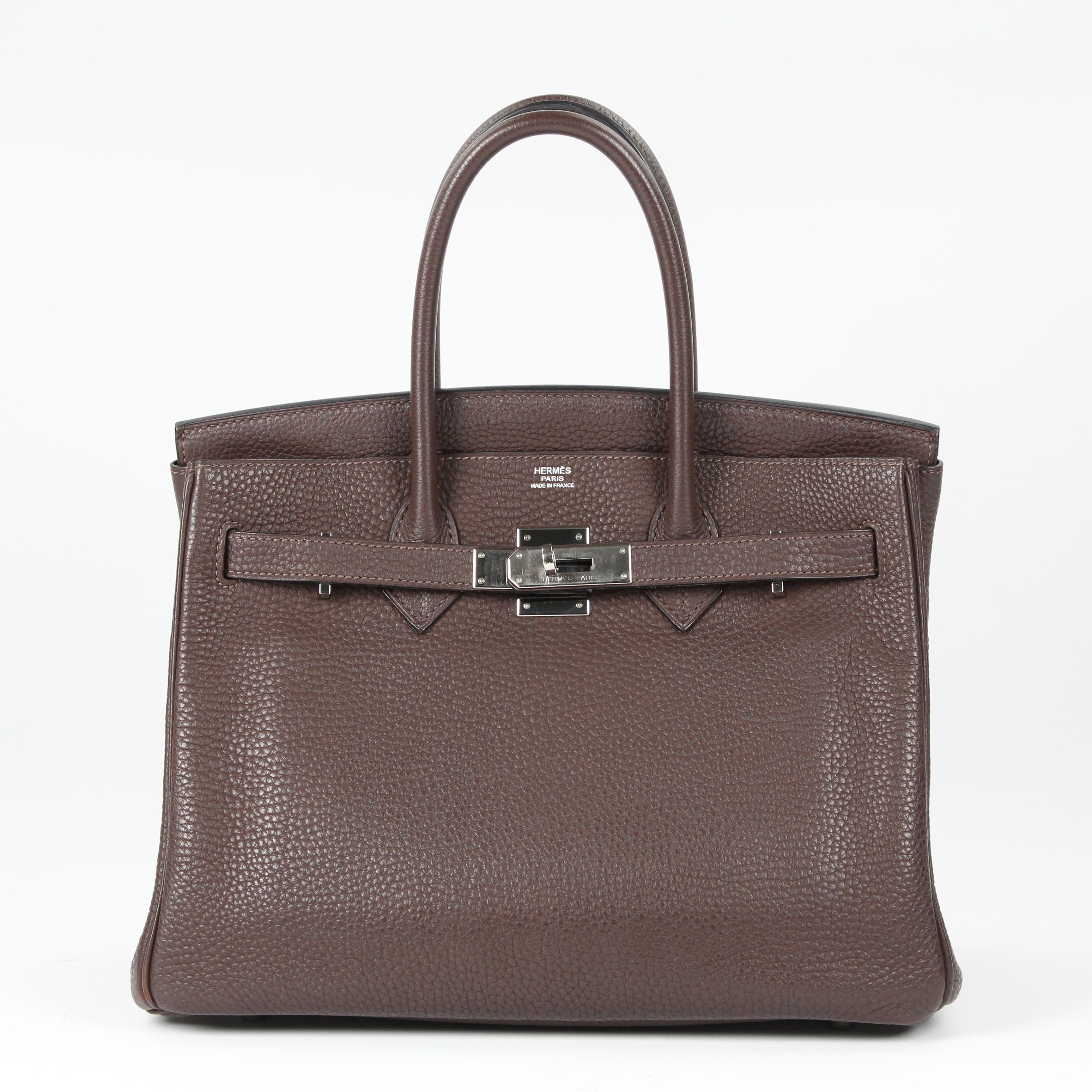 Behold the ultimate dream bag! This is an authentic HERMES Taurillon Clemence Birkin 30 in Chocolate. This classic handbag is beautifully crafted of Clemence calfskin leather in brown. The bag features rolled leather top handles, a short front flap