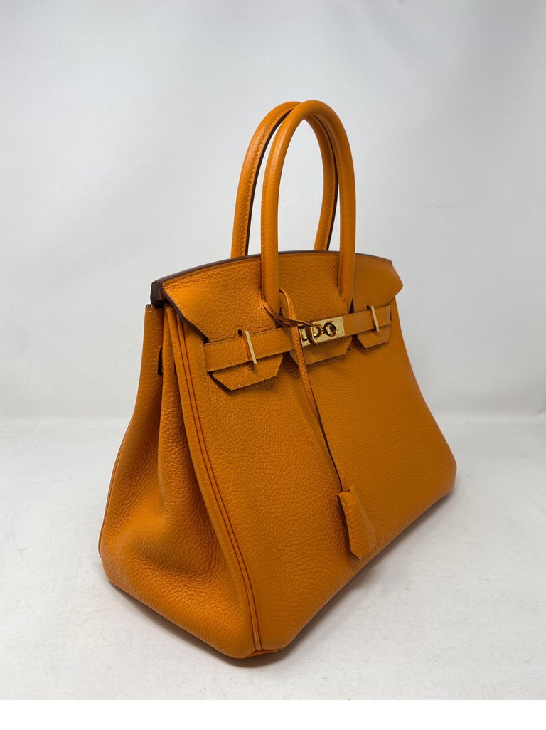 Hermes Birkin 30 Orange Bag. Gold hardware. The most wanted combination. Classic orange with gold hardware. Togo leather. Includes clochette, lock, keys, and dust cover. Guaranteed authentic. 