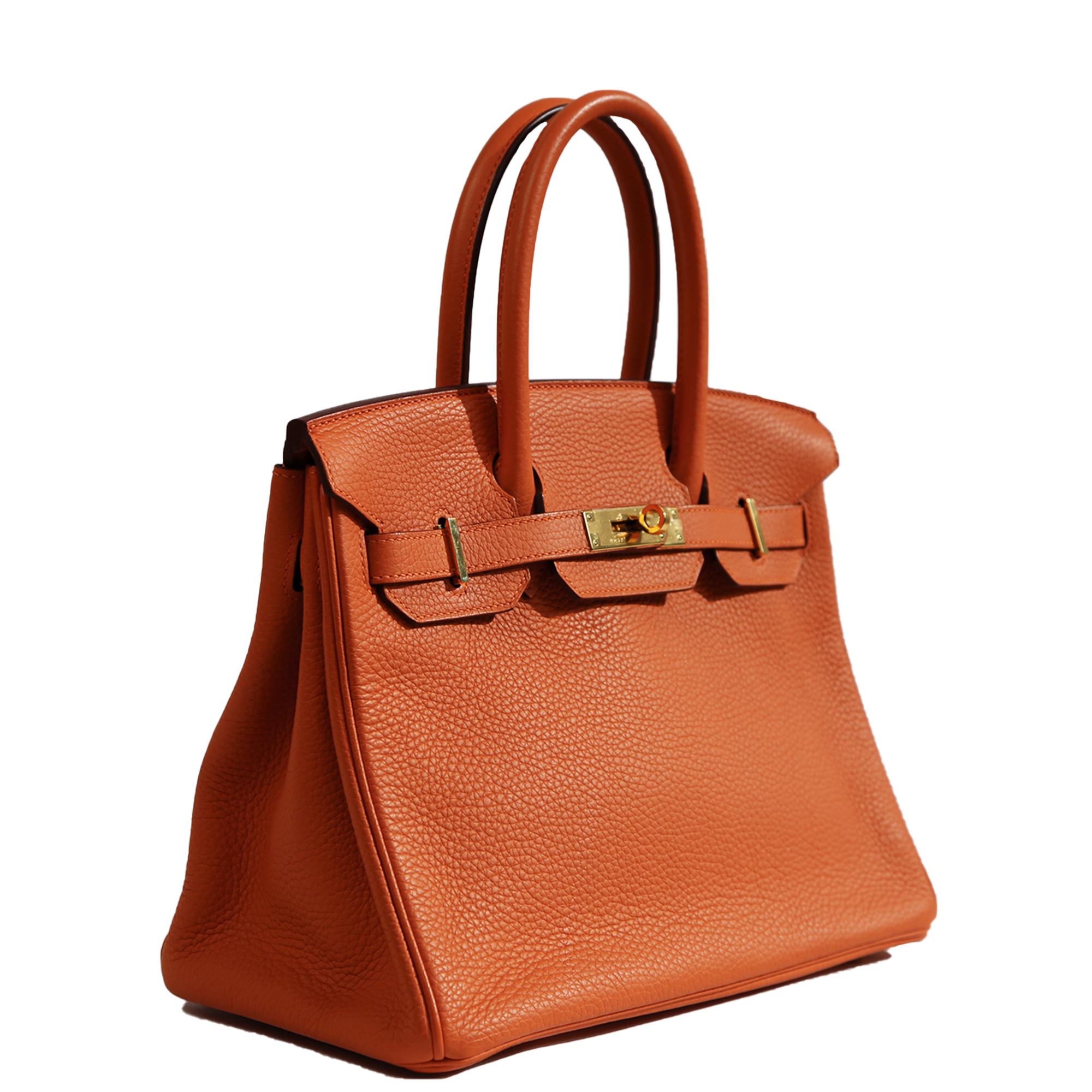 - Orange colour
- Clemence leather
- Gold-tone hardware
- Rolled leather top handles
- Twist-lock fastening

- Stamp: G square, 2003
- Comes with dust bag, clochette, key, padlock and raincoat
- Condition: Excellent
This pre-owned bag is in