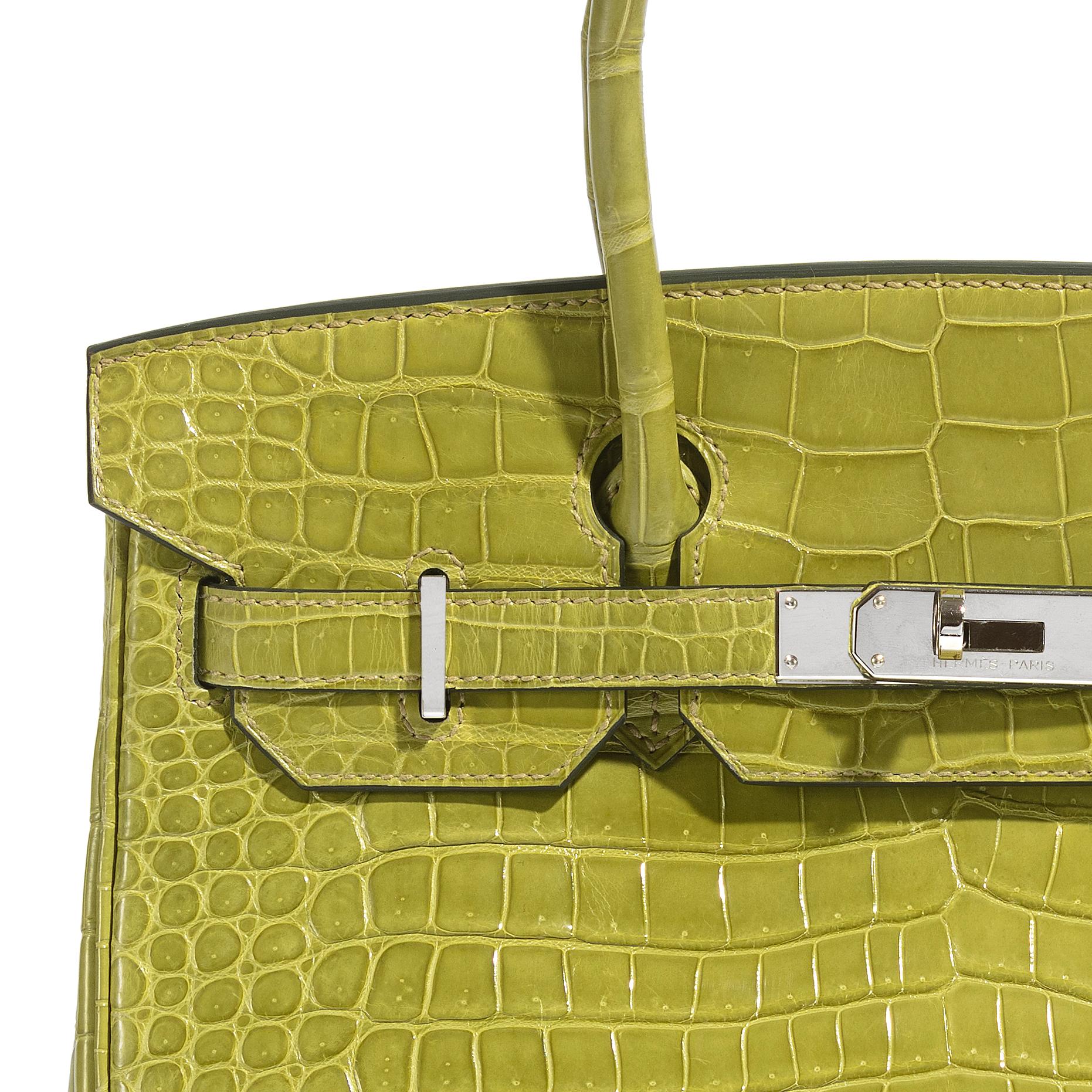 Expertly crafted from exotic porosus leather in Vert Chartreuse, this Hermès Birkin 30 is a true collector's item. It is embellished with palladium hardware and has a zipped compartment inside to keep your most-used cards close at hand. This Birkin