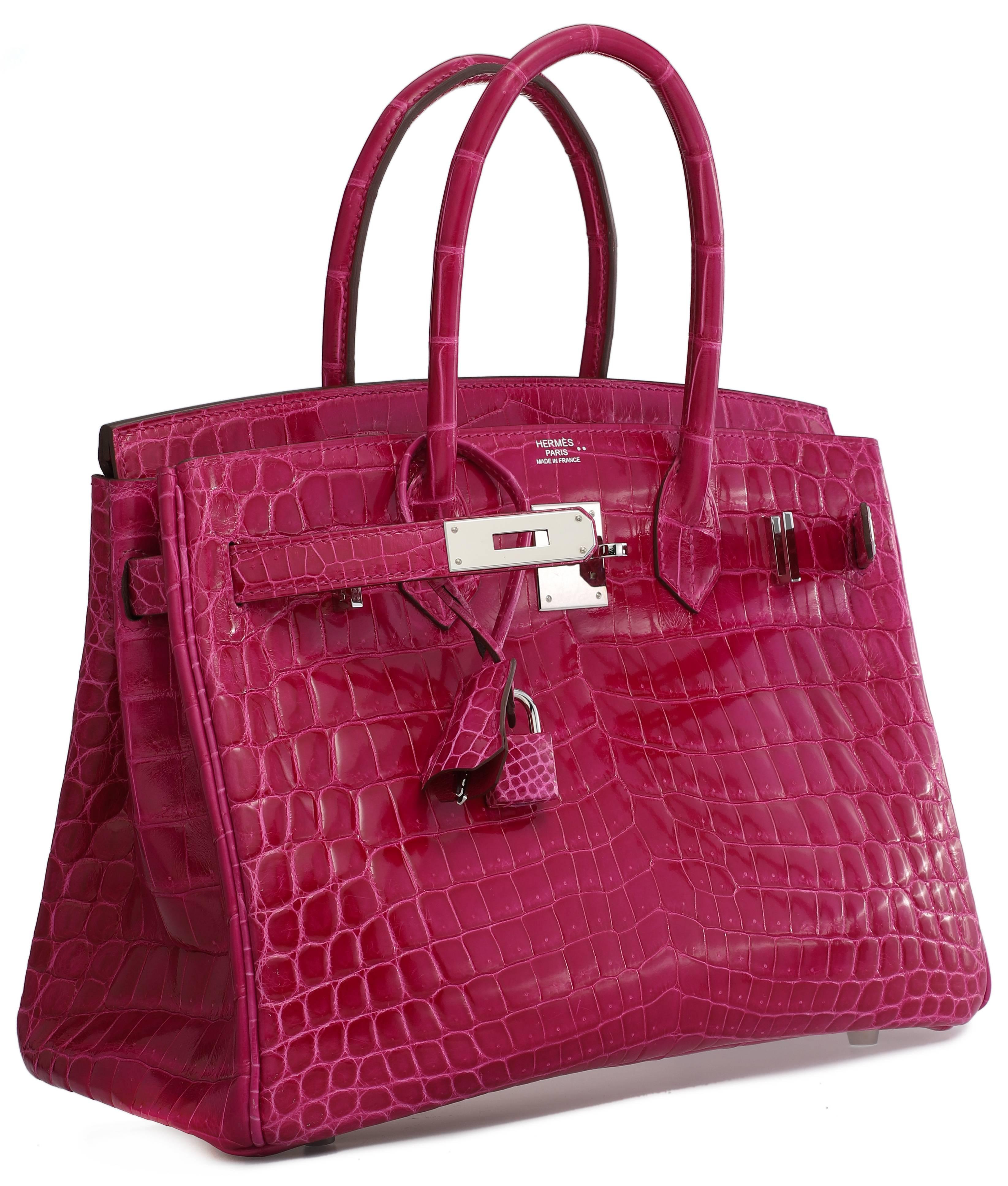 HERMES Birkin 30 vibrant rose scheherazade Niloticus crocodile with palladium hardware. Appears to have never been used. Hardware intact although protective plastics are missing. Extremely tiny wear on feet. A tiny wear mark on 1 corner. Stamp Q in